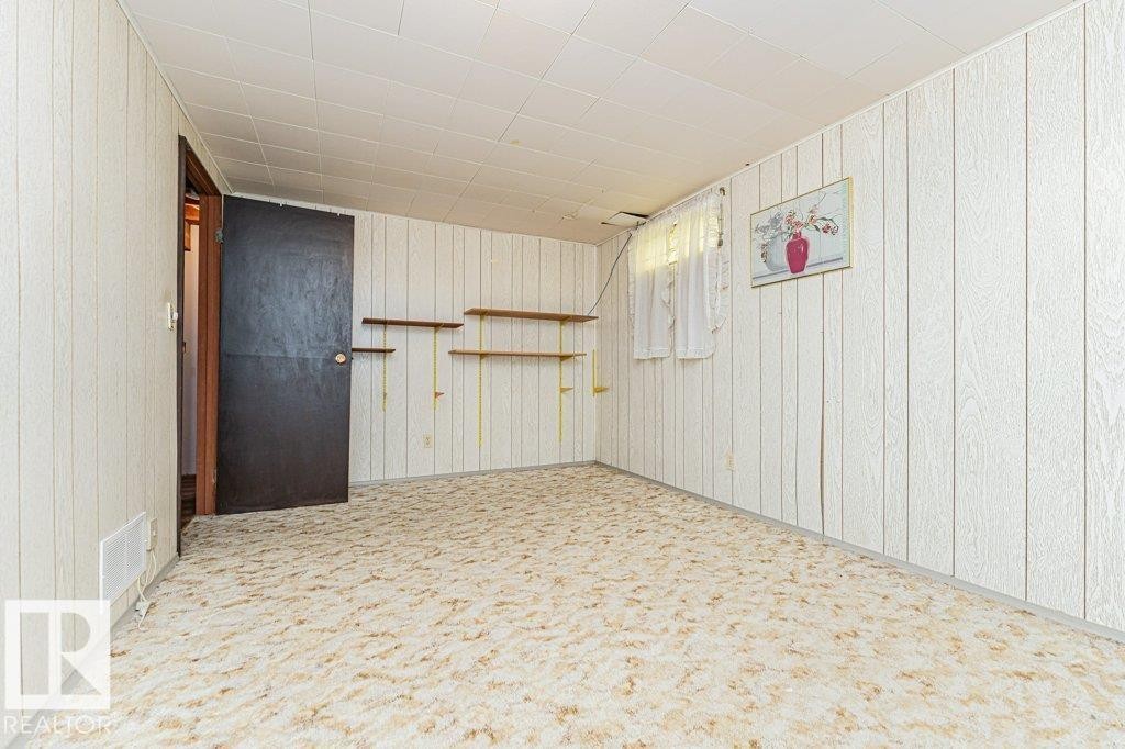Room featuring light-colored patterned carpet, white paneled walls, and a white ceiling - 8804 19 Avenue, Edmonton, AB - Indoor Photo Showing Other Room