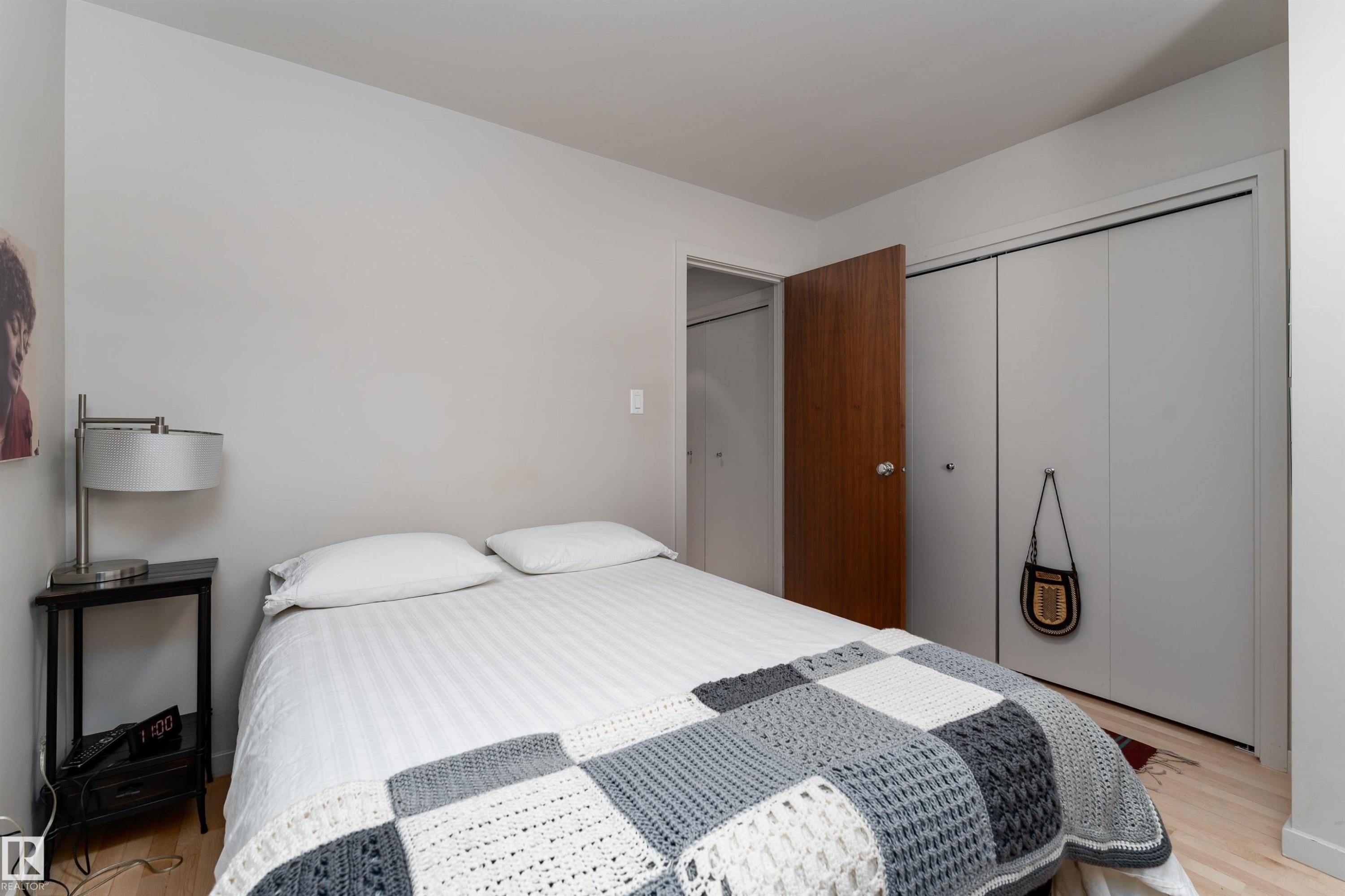 Room featuring light-colored walls and light wood flooring - 9715 141 Street Nw, Edmonton, AB - Indoor Photo Showing Bedroom