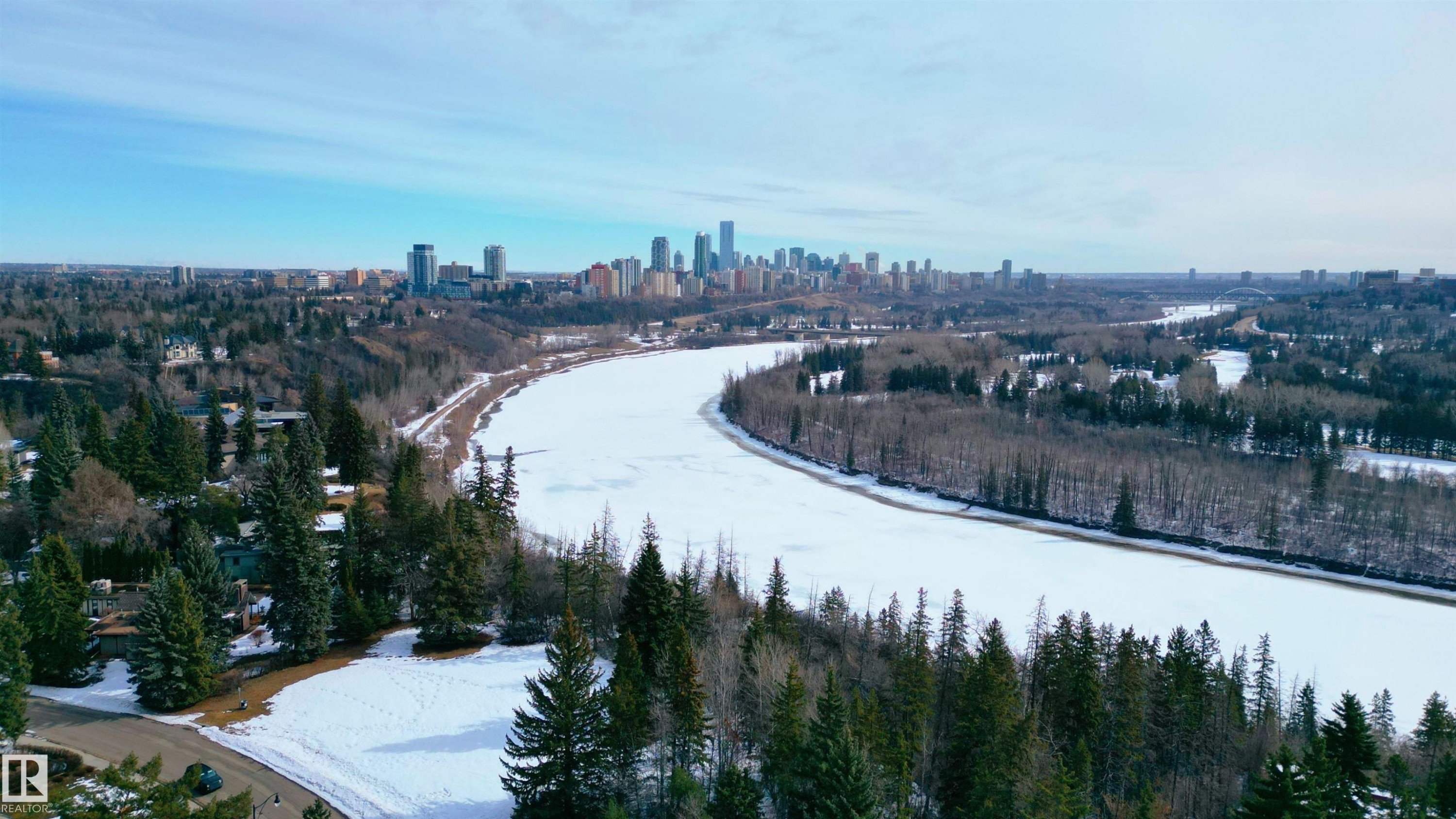 This aerial view showcases the surrounding community with a prominent skyline visible in the distance - 9715 141 Street Nw, Edmonton, AB - Outdoor With View