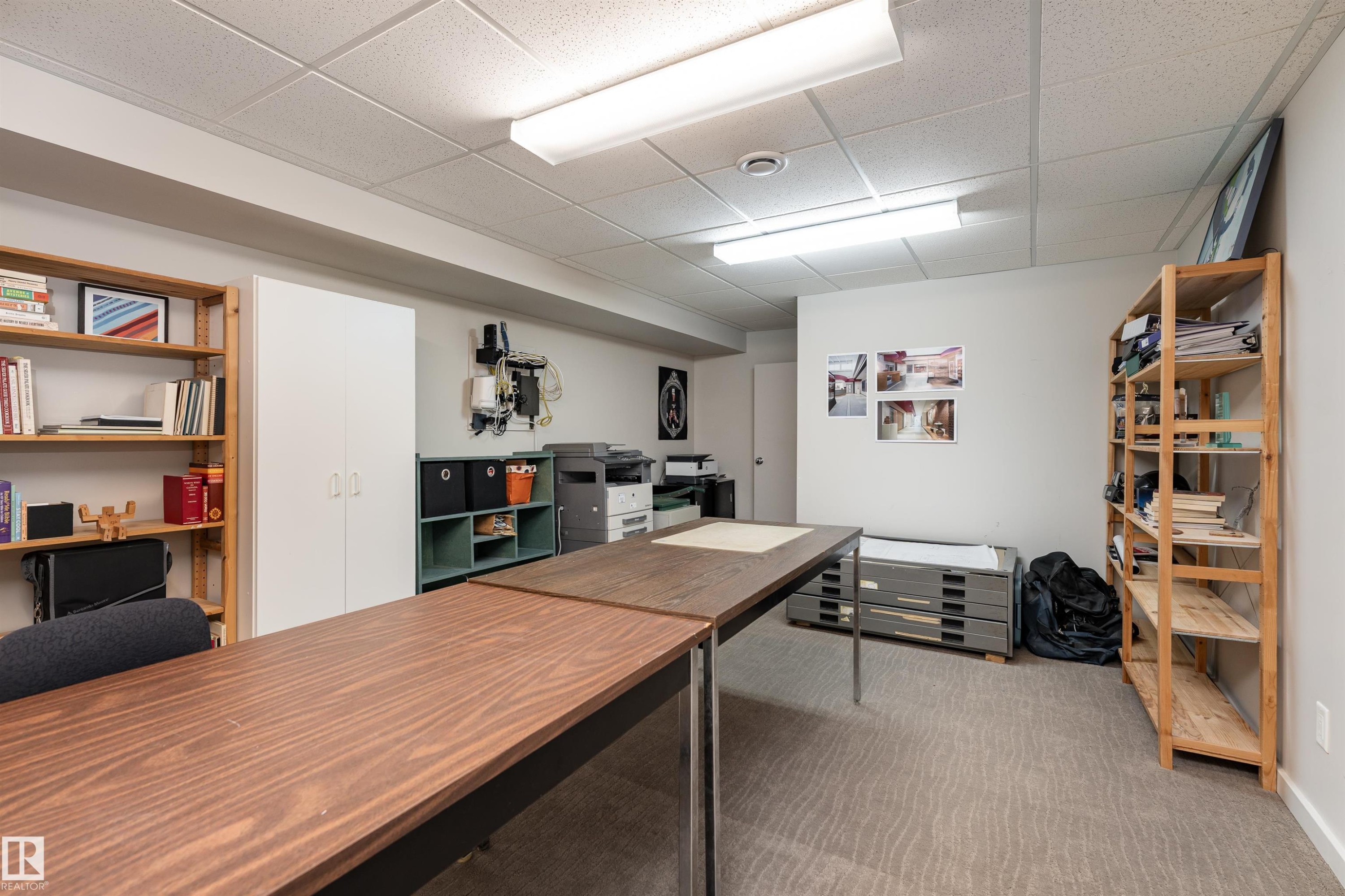 This versatile room features a drop ceiling, ample overhead lighting, and durable carpeting - 9715 141 Street Nw, Edmonton, AB - Indoor