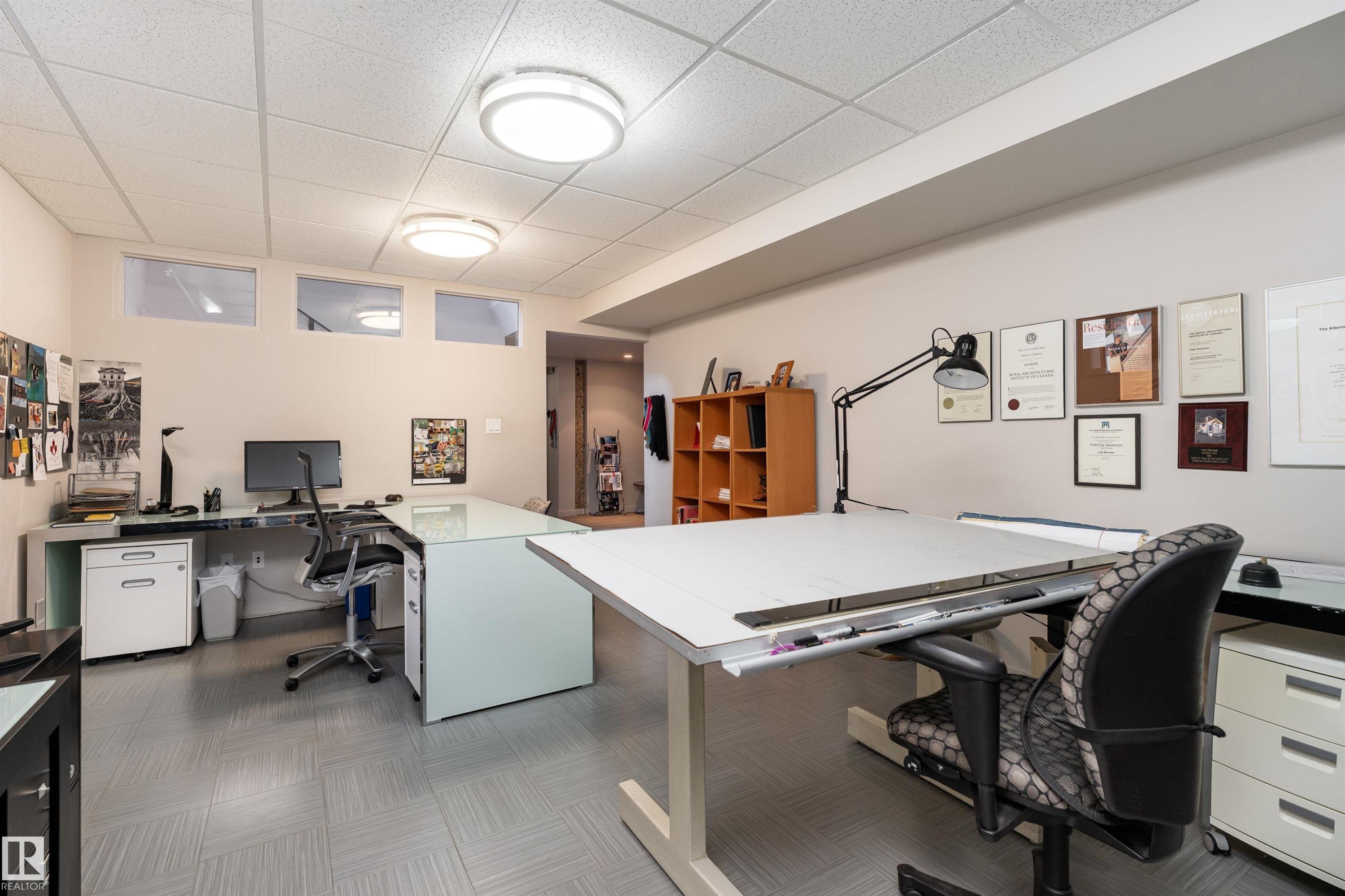 Versatile room featuring a drop ceiling with flush-mount lighting, light-colored walls, and a patterned floor - 9715 141 Street Nw, Edmonton, AB - Indoor Photo Showing Office