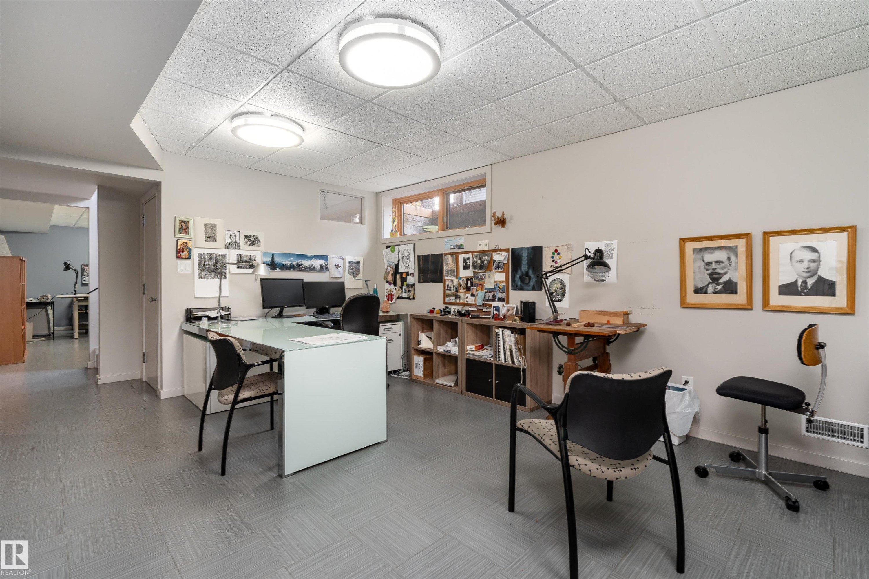 The property features a versatile room with light grey walls, grey floor tiles, and recessed lighting fixtures - 9715 141 Street Nw, Edmonton, AB - Indoor