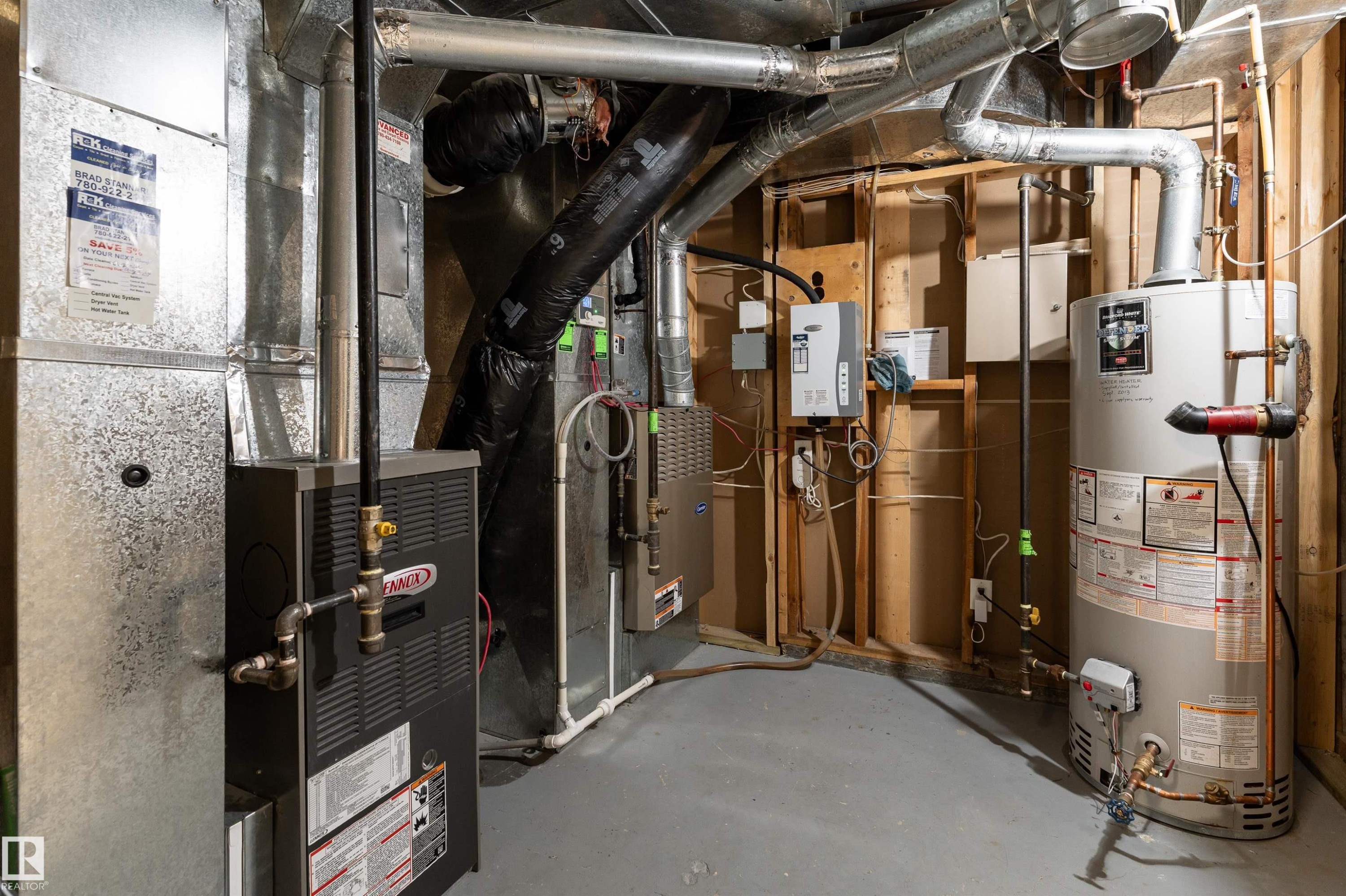 Utility area featuring a water heater, furnace, and exposed ductwork - 9715 141 Street Nw, Edmonton, AB - Indoor Photo Showing Basement