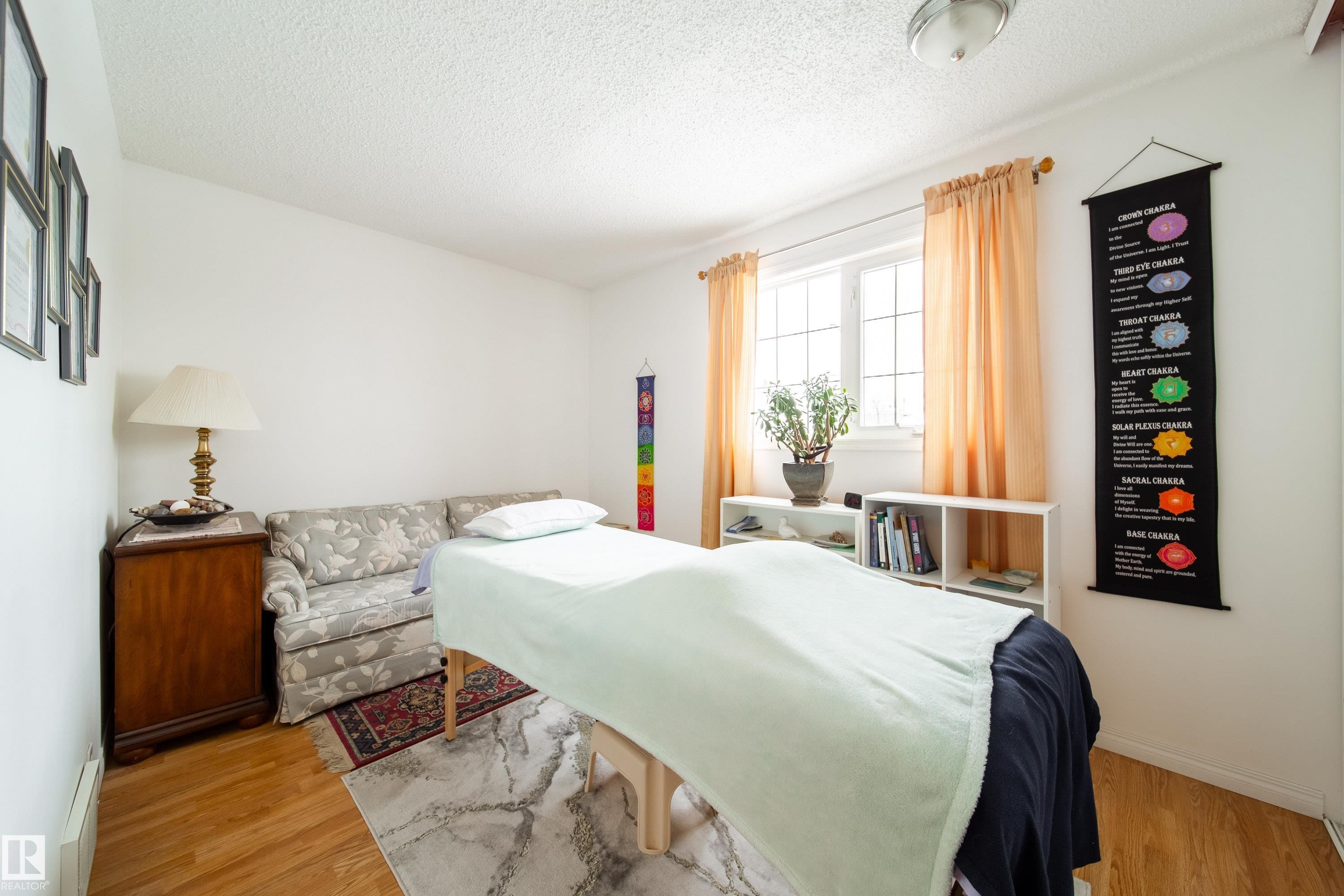 This room features light-colored walls and wood flooring - 1104 35 Street, Edmonton, AB - Indoor Photo Showing Bedroom