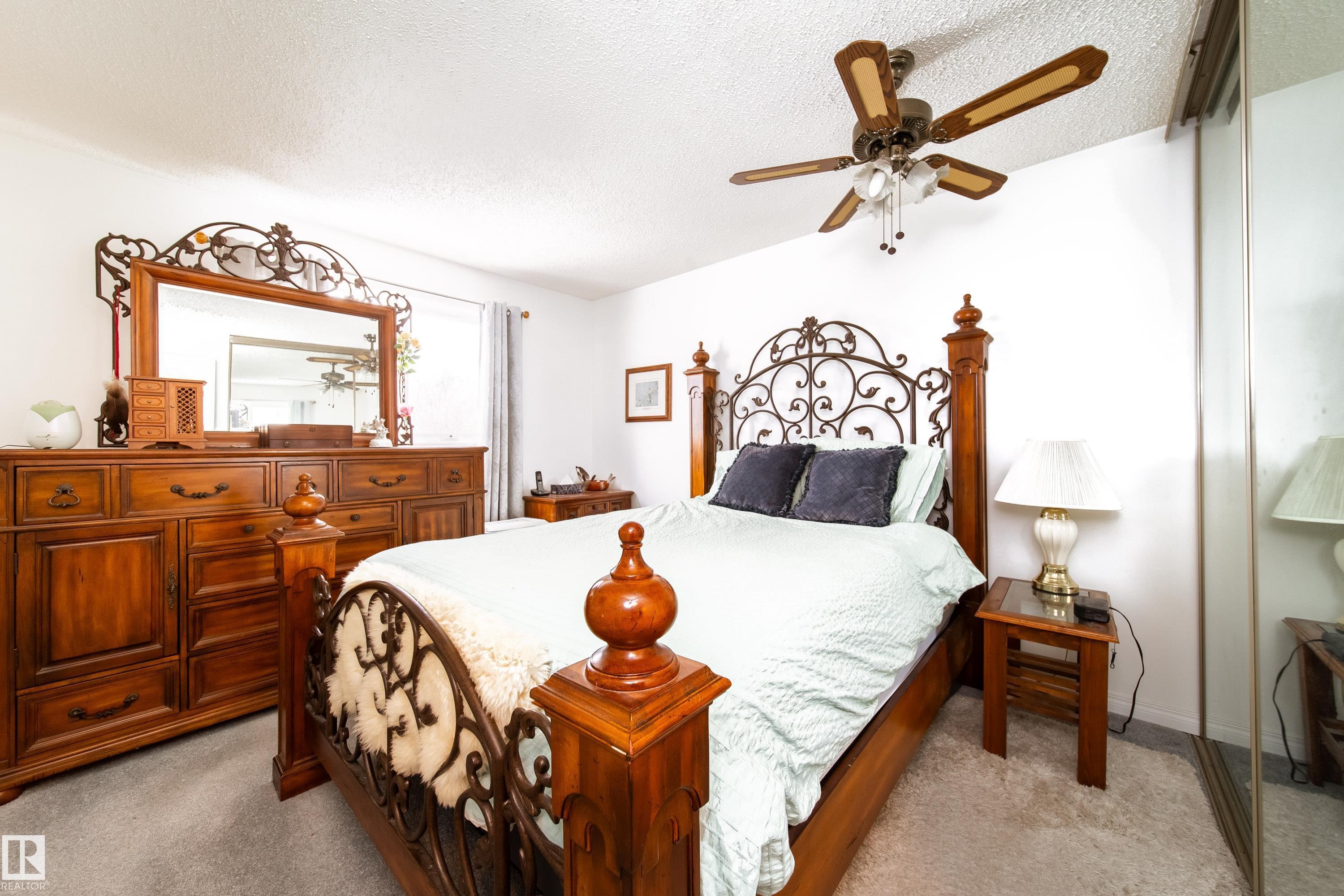 This room features light-colored walls and a ceiling fan with light fixtures - 1104 35 Street, Edmonton, AB - Indoor Photo Showing Bedroom