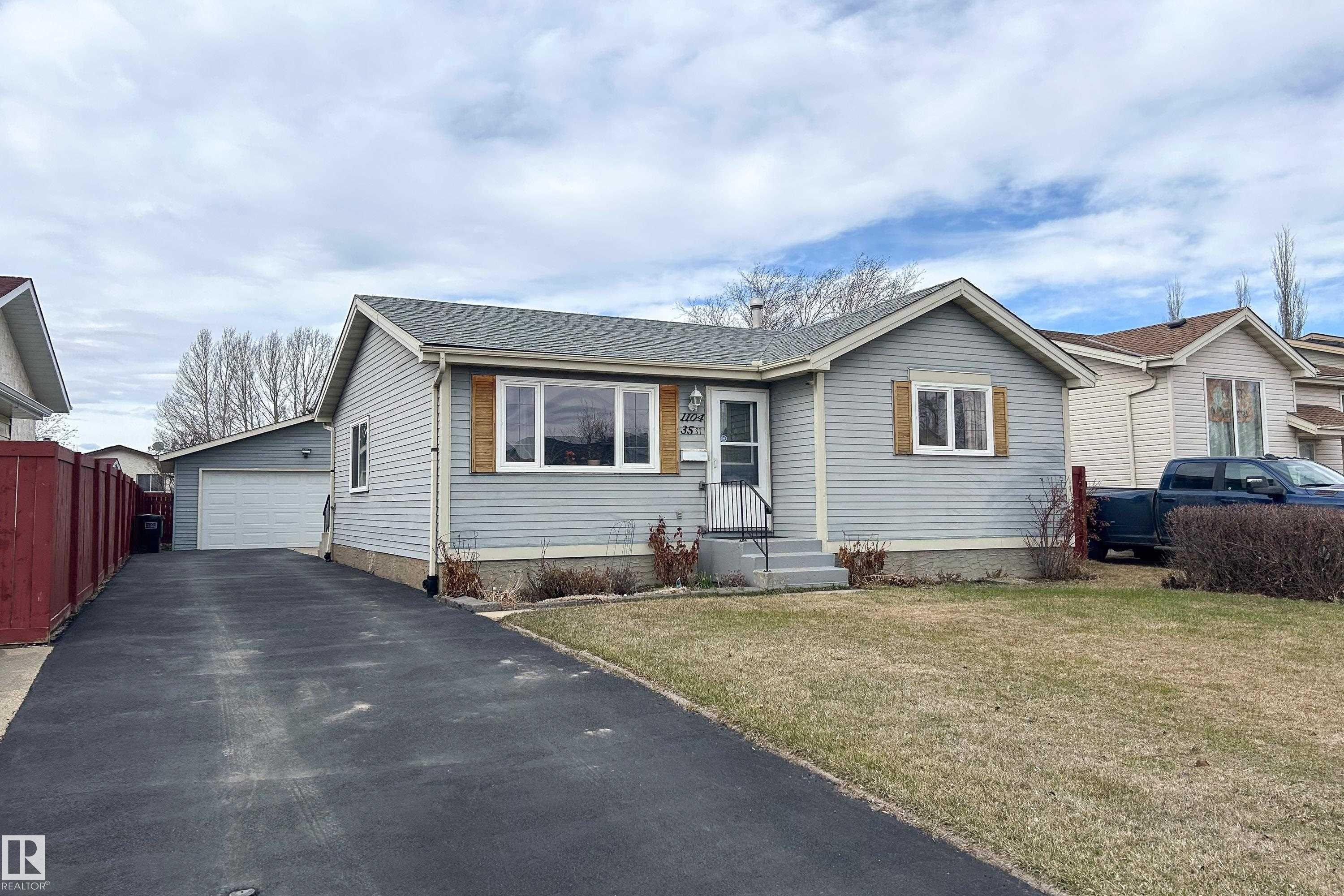 Light grey siding exterior with a dark grey shingled roof - 1104 35 Street, Edmonton, AB - Outdoor