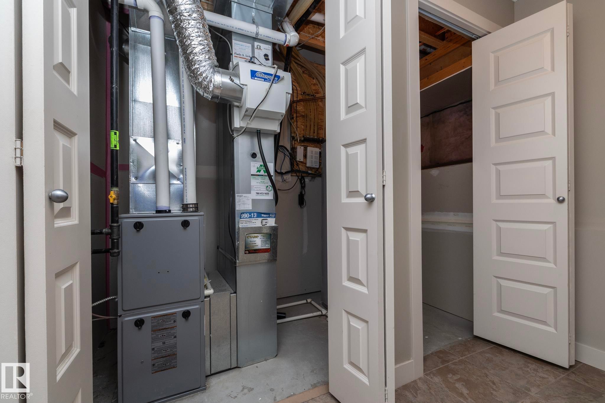 Utility space featuring a furnace, air ducts, and exposed wood beams - 1403 Cunningham Drive, Edmonton, AB - Indoor
