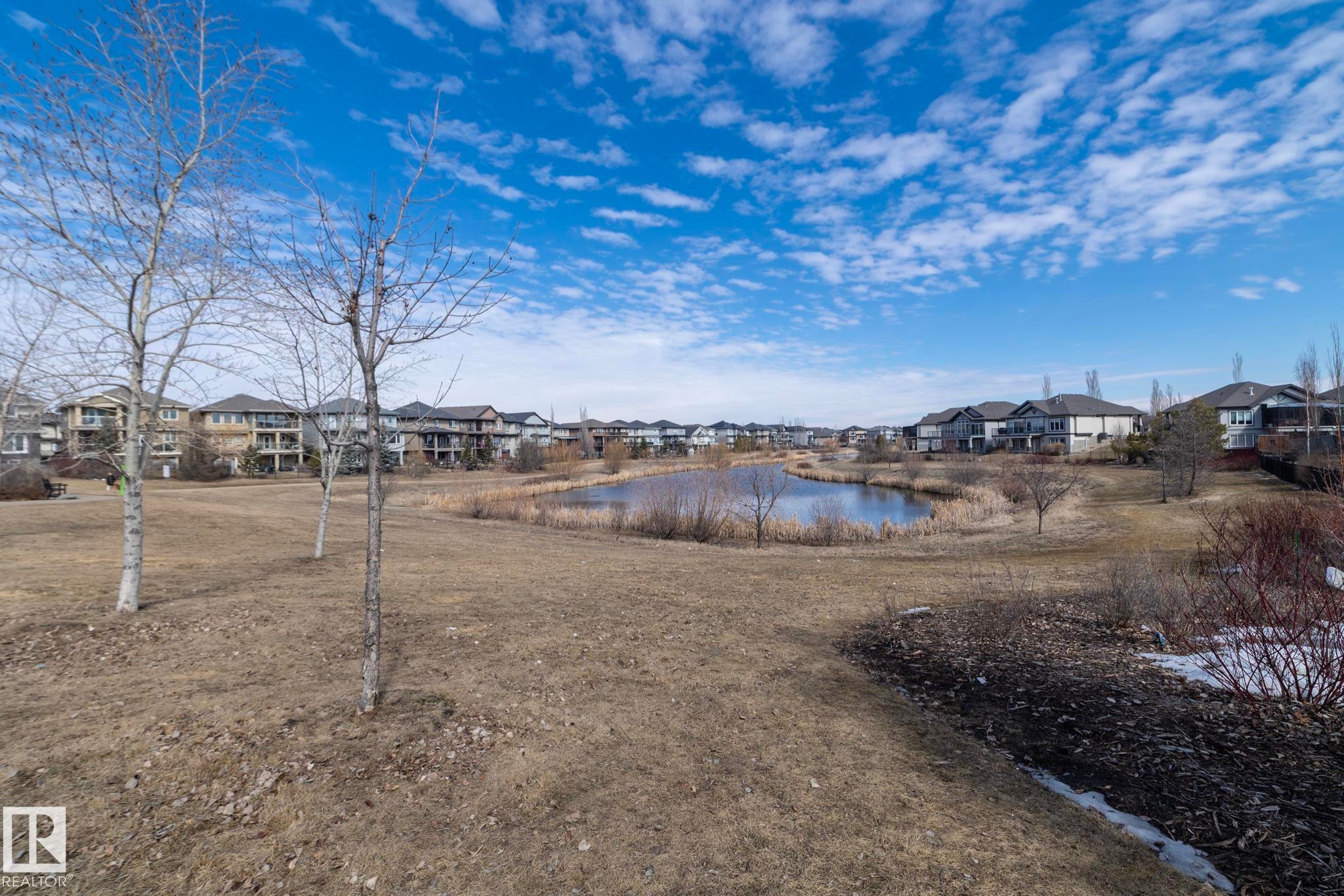 This property offers scenic views of a pond with surrounding natural vegetation - 1403 Cunningham Drive, Edmonton, AB - Outdoor With View