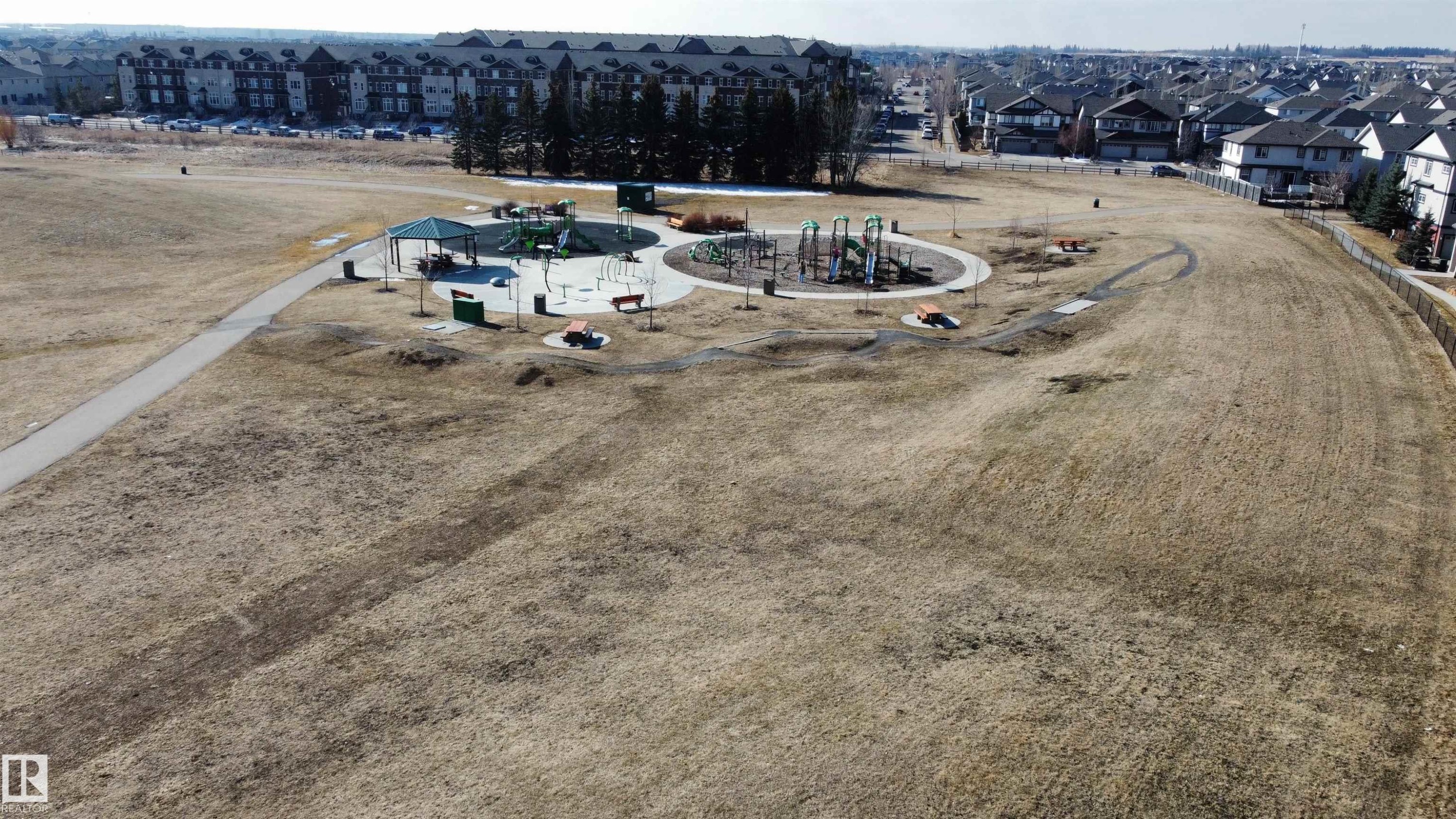This aerial view captures the surrounding neighborhood, highlighting residential properties and a public park area - 1403 Cunningham Drive, Edmonton, AB - Outdoor With View