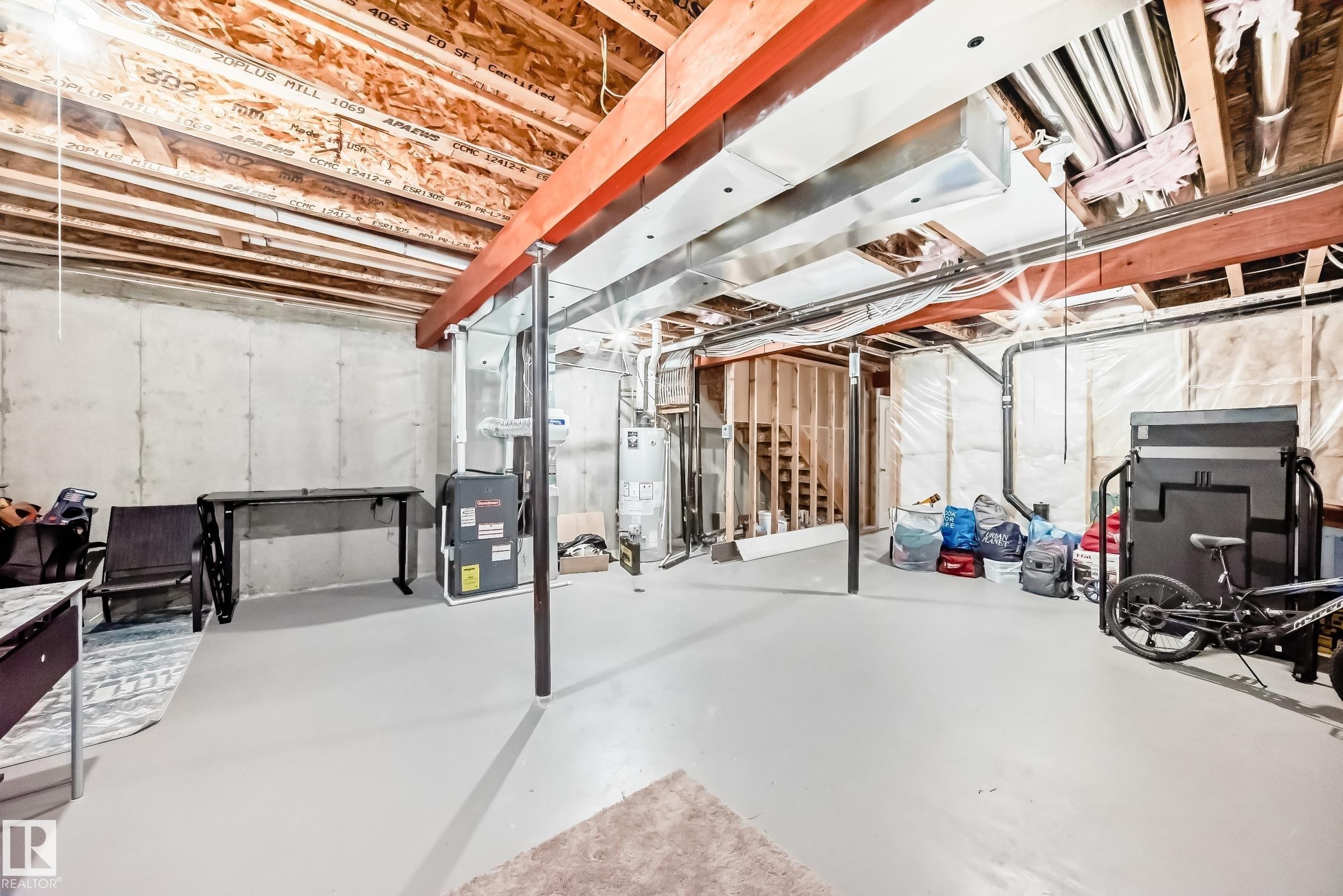 The unfinished basement provides a spacious area with concrete walls and an exposed ceiling - 8 13838 166Ave, Edmonton, AB - Indoor Photo Showing Basement