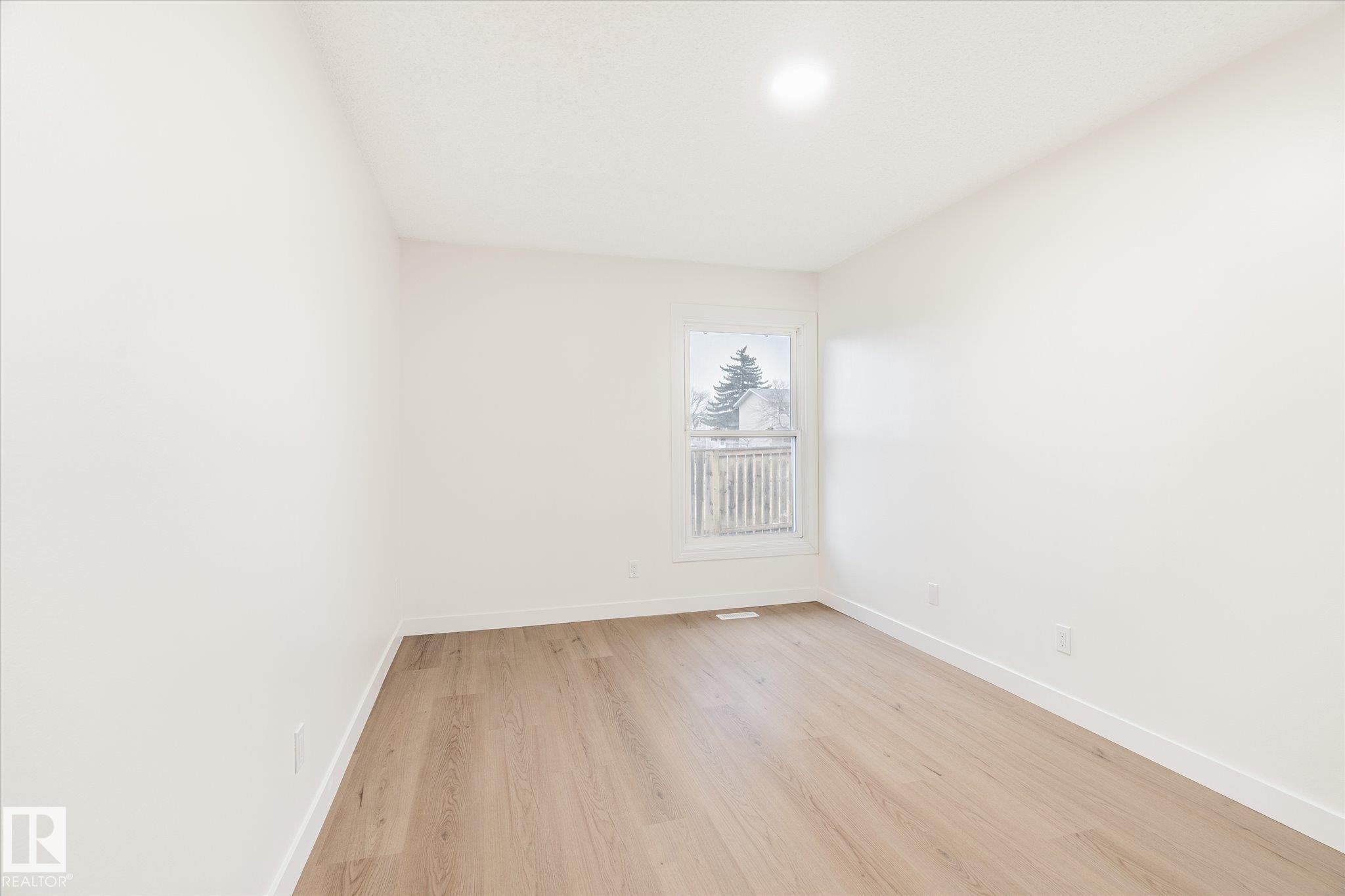 Room with light wood flooring, white walls, and a window providing natural light - 6540 184 Street, Edmonton, AB - Indoor Photo Showing Other Room
