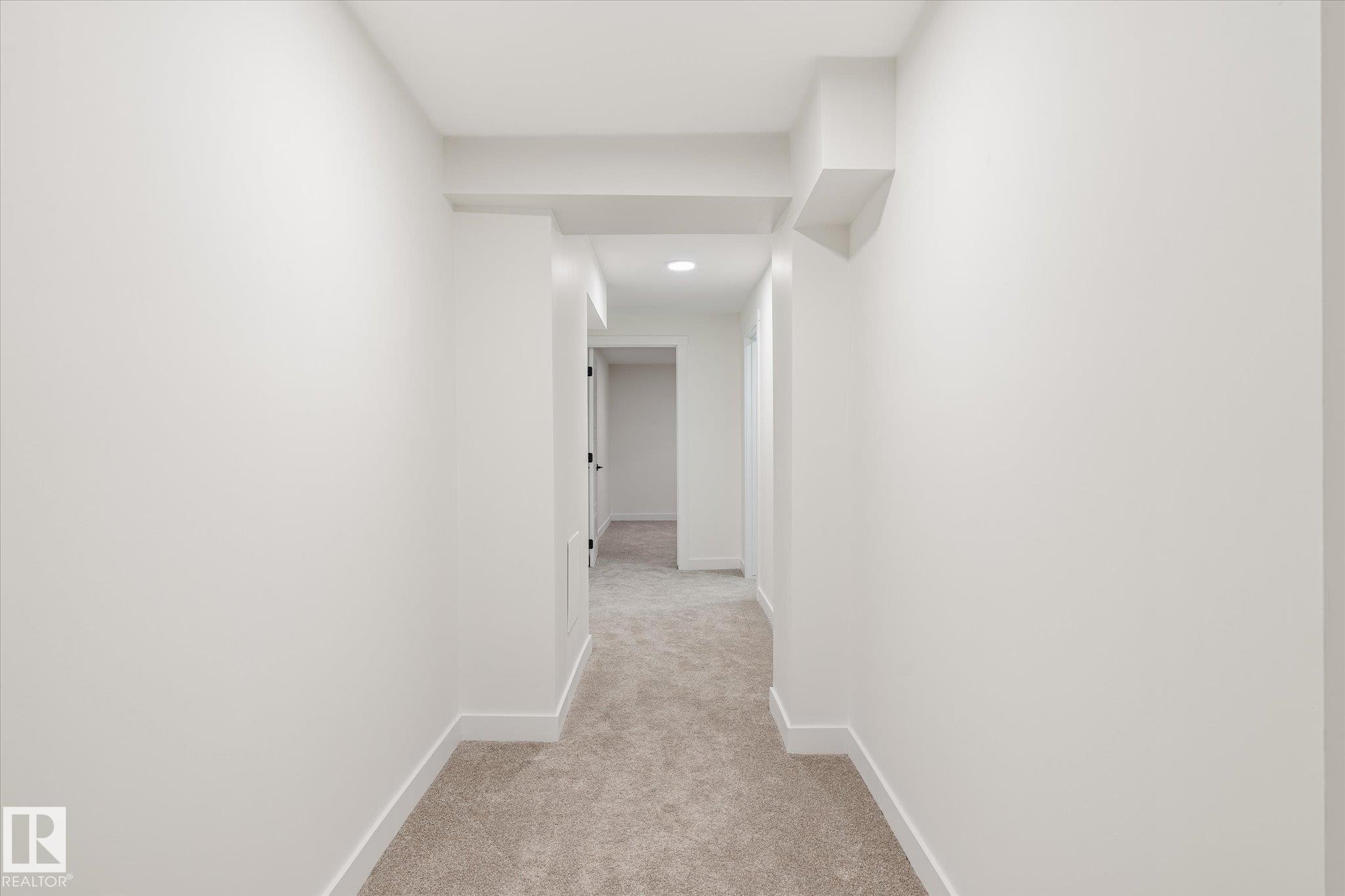 This hallway features light-colored walls, recessed lighting, and carpeting - 6540 184 Street, Edmonton, AB - Indoor Photo Showing Other Room