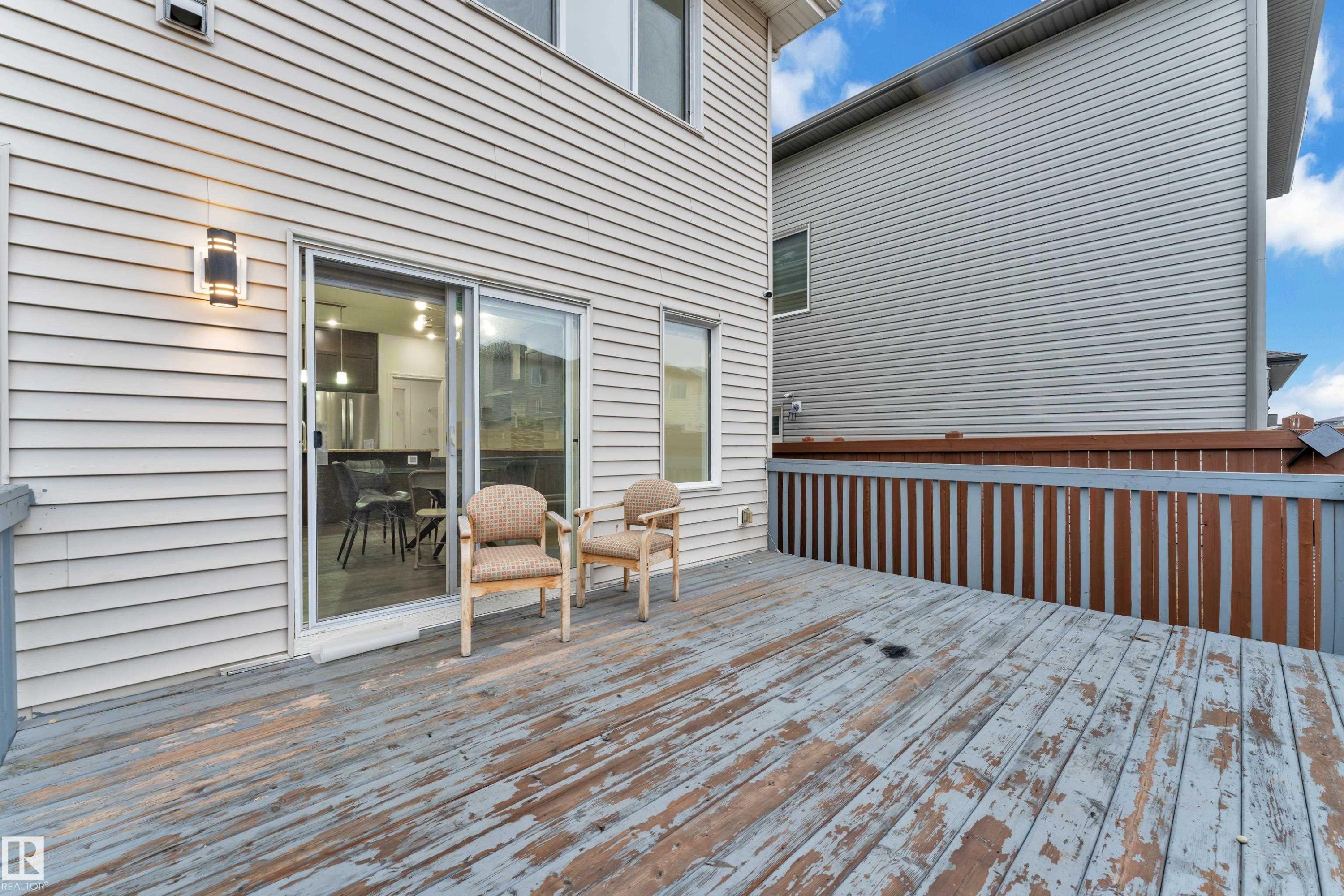 This property features an exterior deck with a wooden railing - 3235 13 Avenue, Edmonton, AB - Outdoor With Deck Patio Veranda With Exterior
