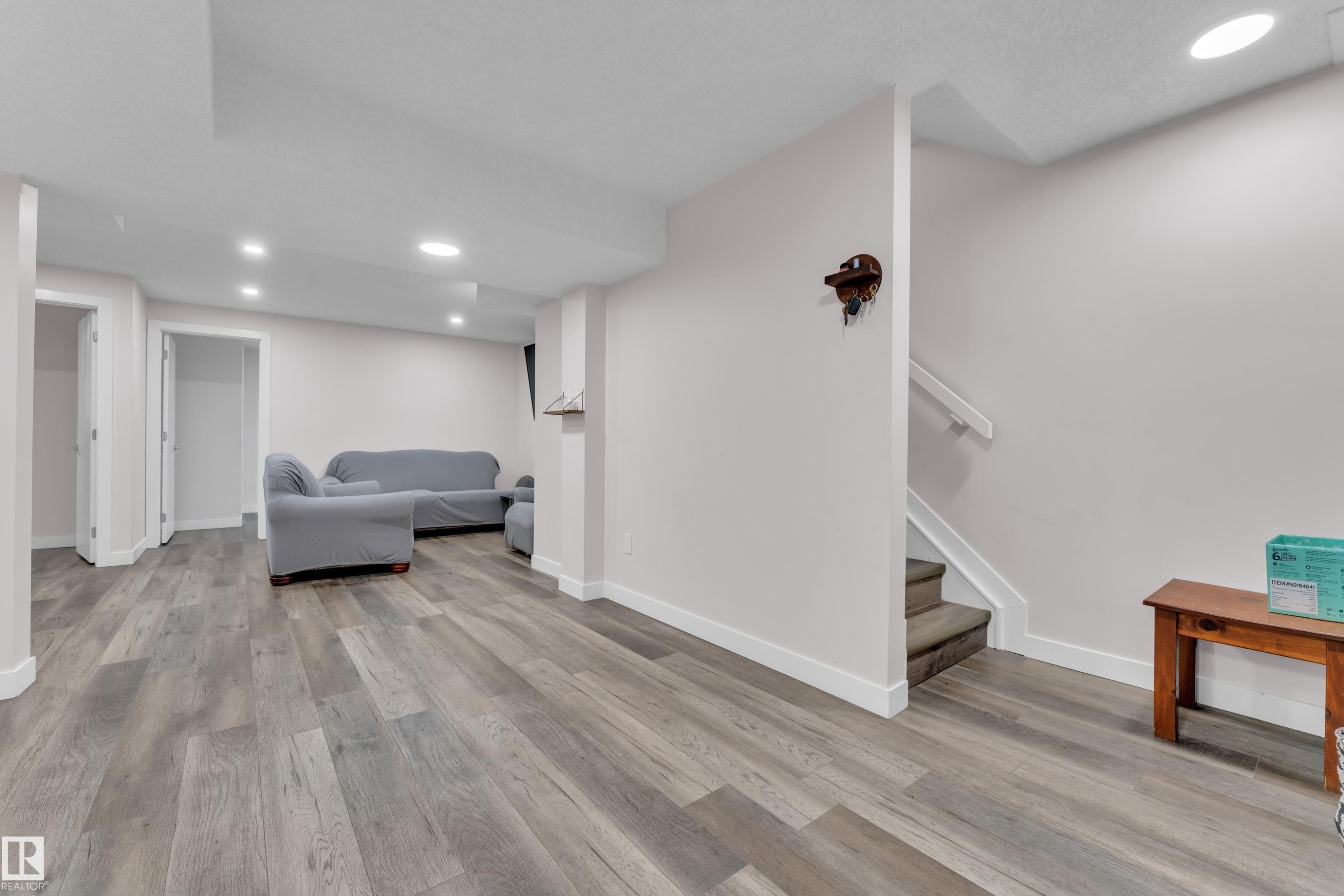 Spacious interior with contemporary plank flooring and recessed lighting - 3235 13 Avenue, Edmonton, AB - Indoor