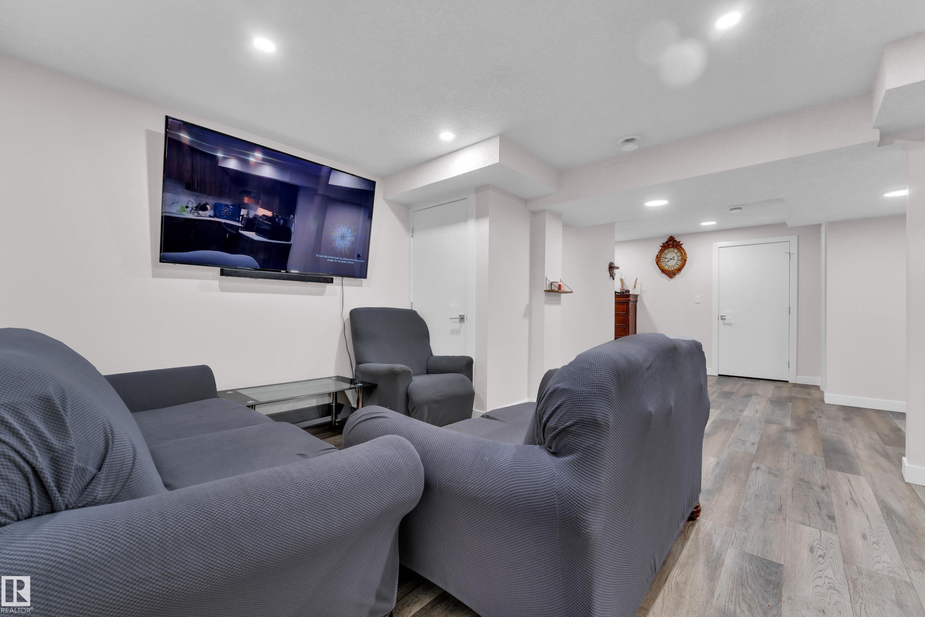 Living space featuring light-colored walls, recessed lighting, and wood-look flooring - 3235 13 Avenue, Edmonton, AB - Indoor