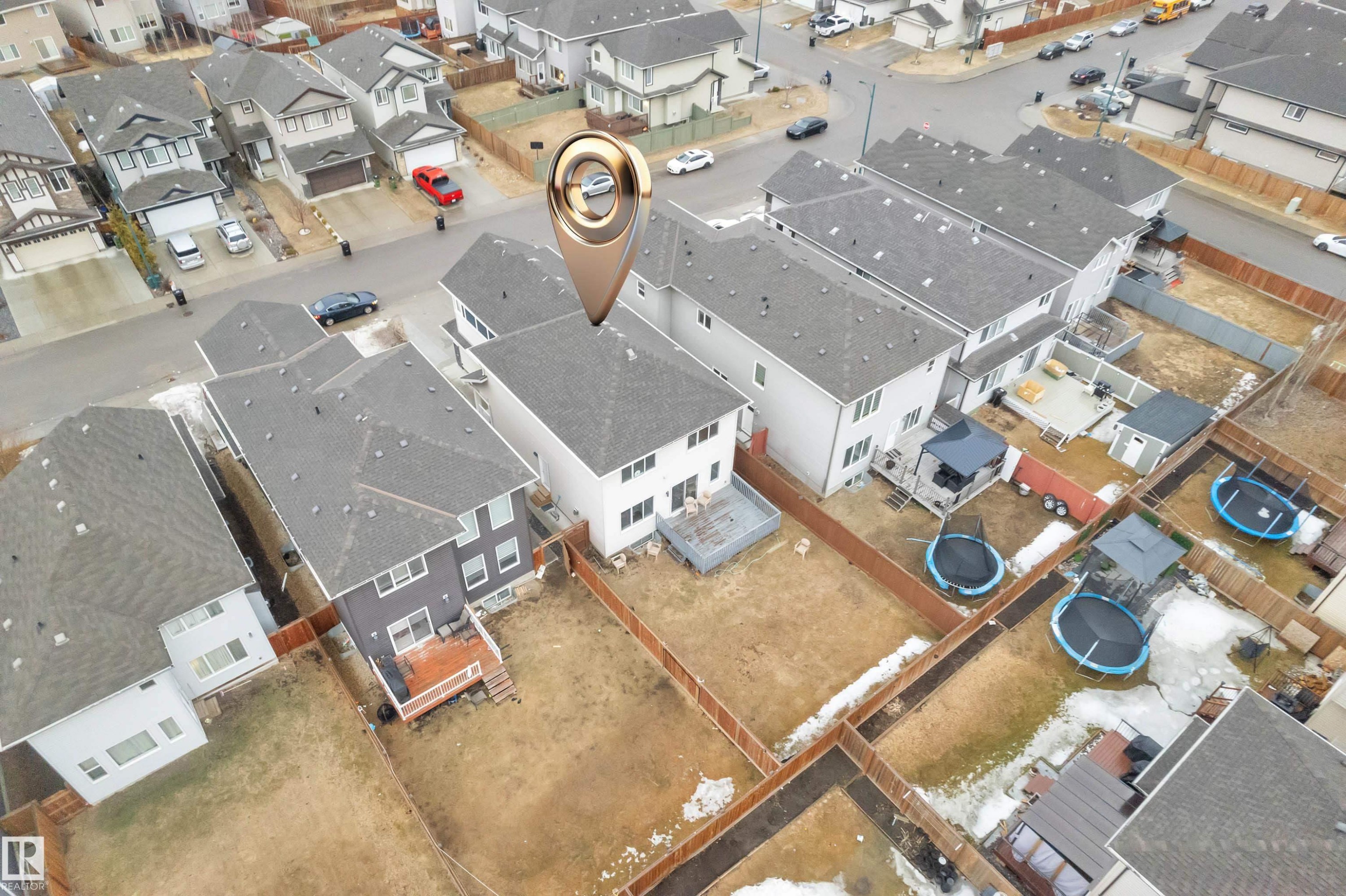 The property features an exterior with a light-colored facade, a gray roof, and a wooden deck - 3235 13 Avenue, Edmonton, AB - Other