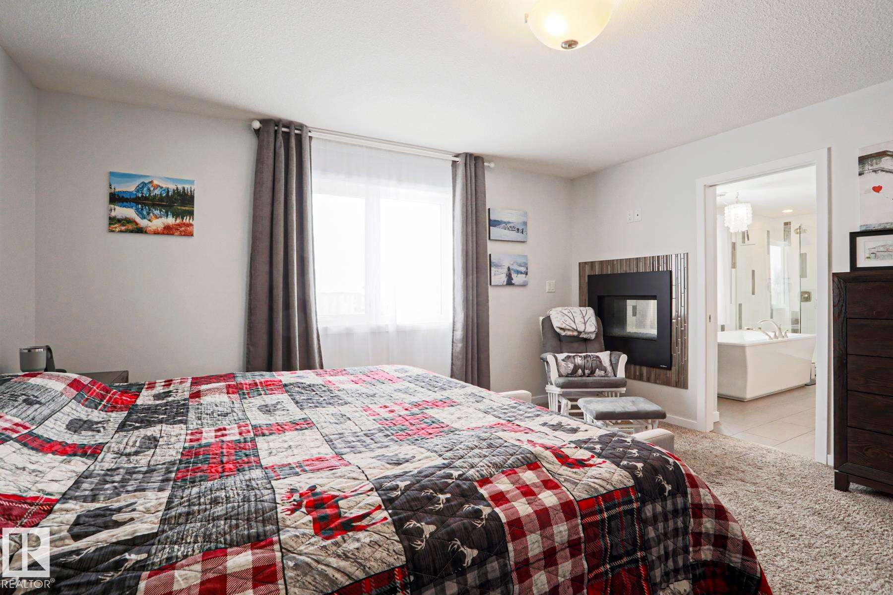 This room features neutral-toned walls, carpeting, and a window with curtains - 18 Enchanted Way, St. Albert, AB