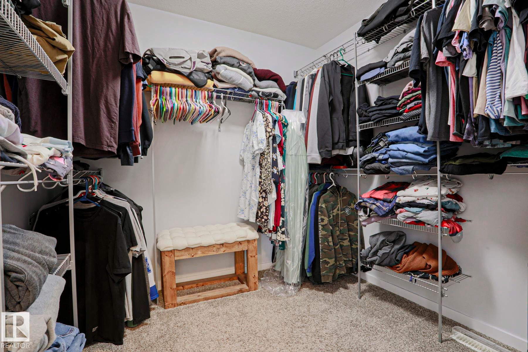 Walk-in closet featuring wire shelving and hanging rods - 18 Enchanted Way, St. Albert, AB