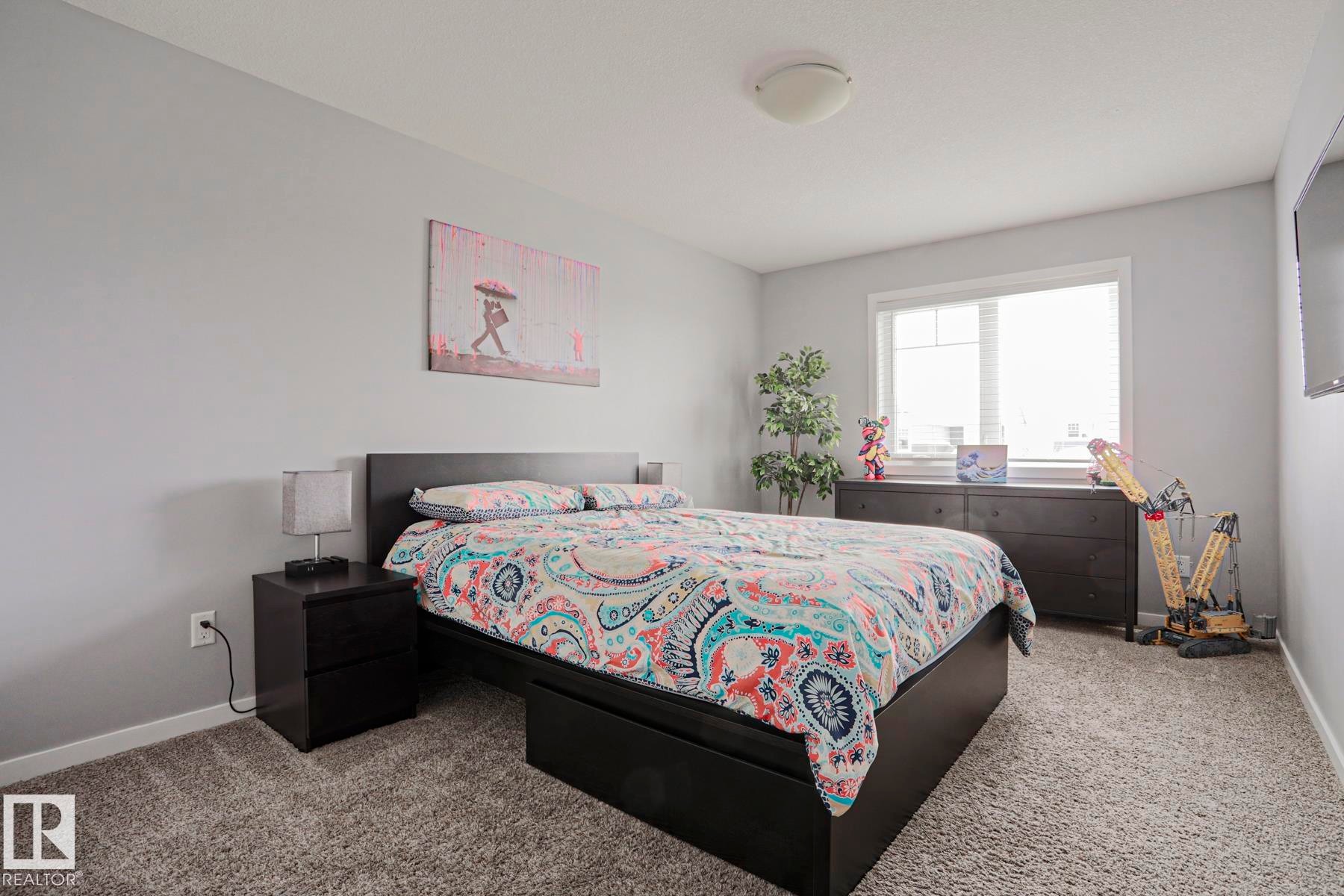 This room features light grey walls and grey carpet flooring - 18 Enchanted Way, St. Albert, AB
