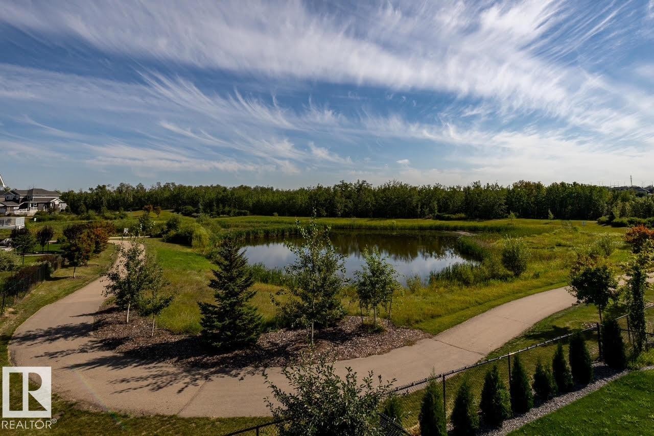 Pond-front property with a naturalized shoreline and surrounding green space - 3419 Chickadee Drive, Edmonton, AB - Outdoor With View