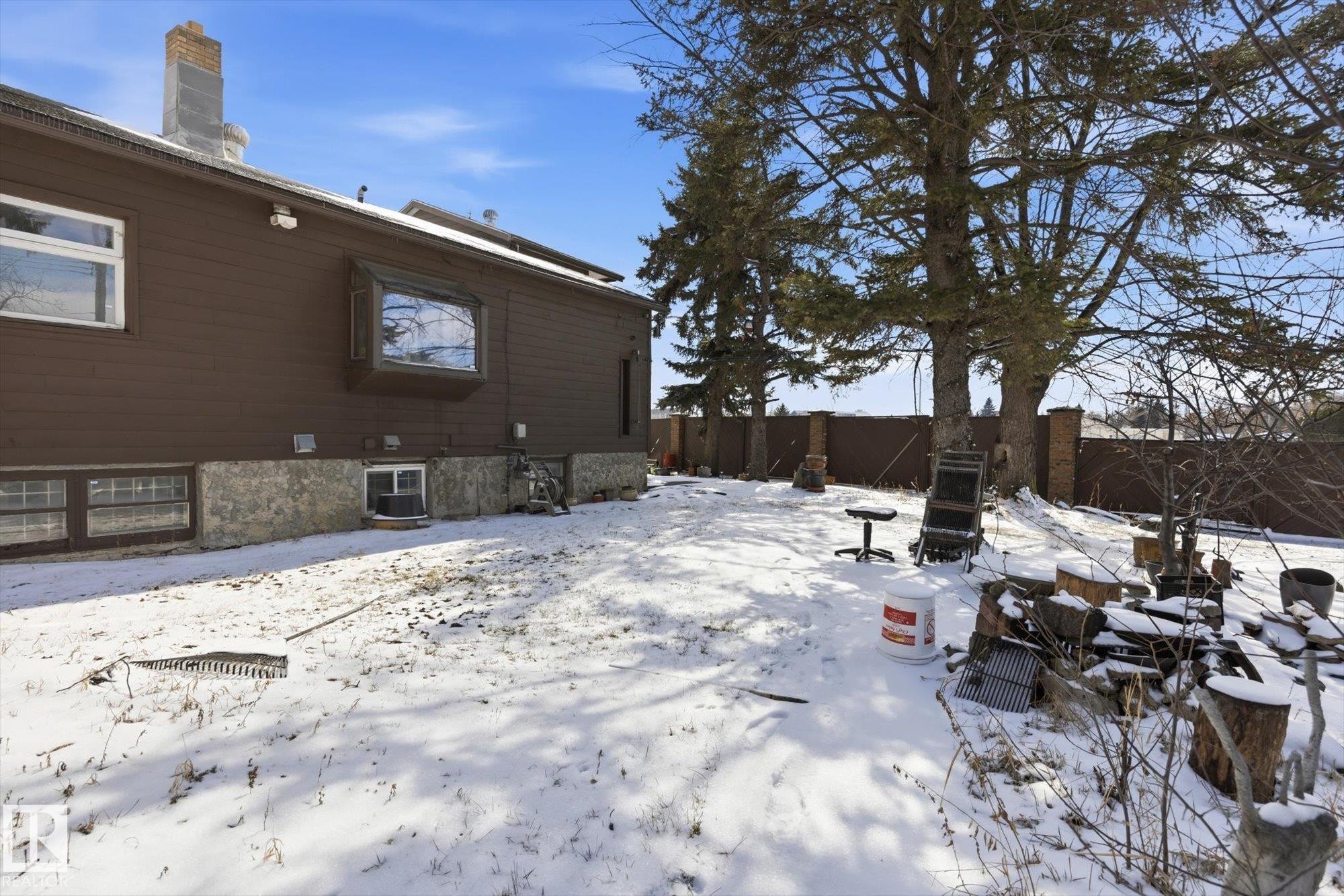 The property features a brown exterior with a stone foundation and a bay window - 11026 110 Avenue, Edmonton, AB - Outdoor