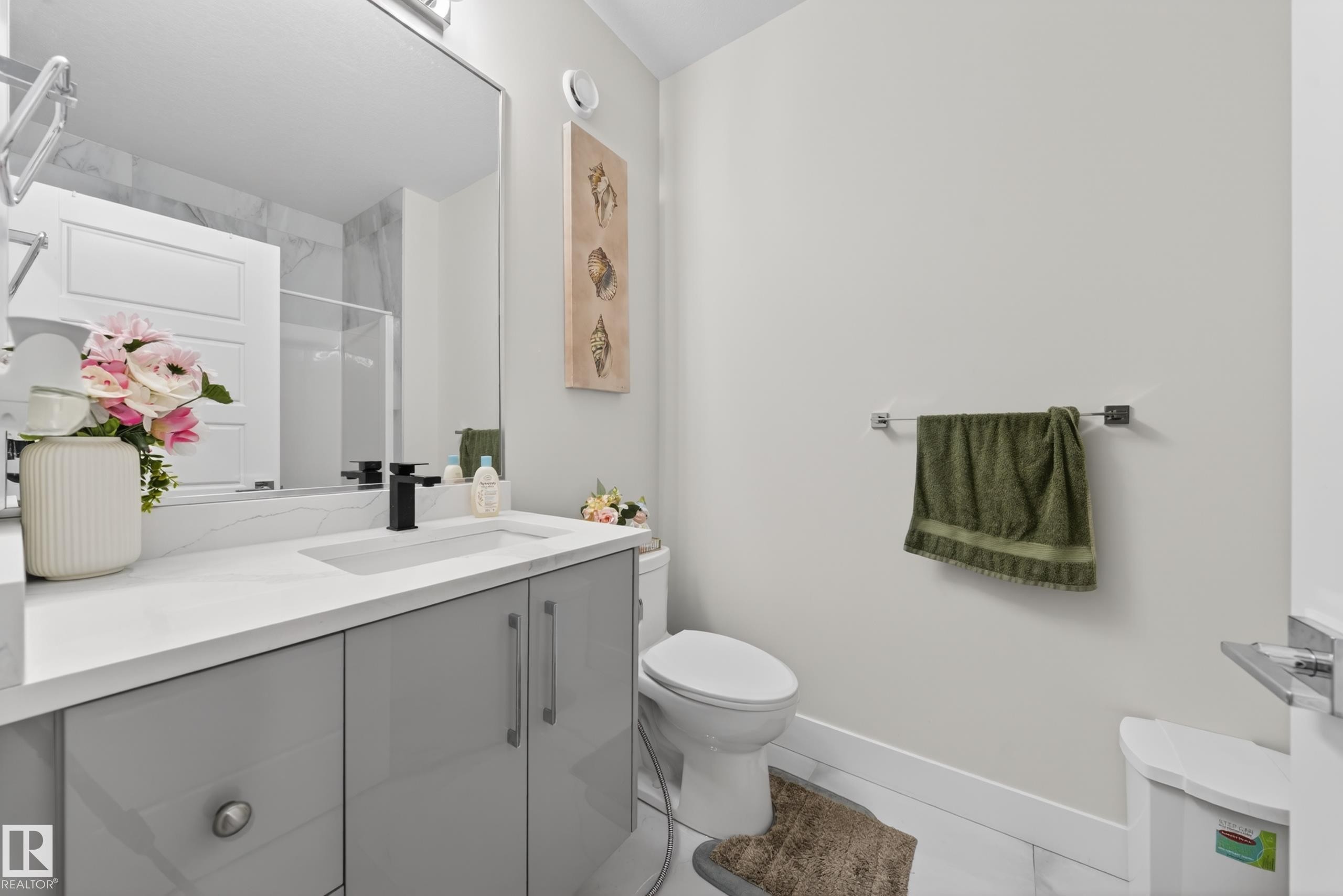 Bathroom featuring a vanity with a white countertop and gray cabinetry, a built-in rectangular sink with a black faucet, and a large mirror - 449 Roberts Crescent, Leduc, AB - Indoor Photo Showing Bathroom