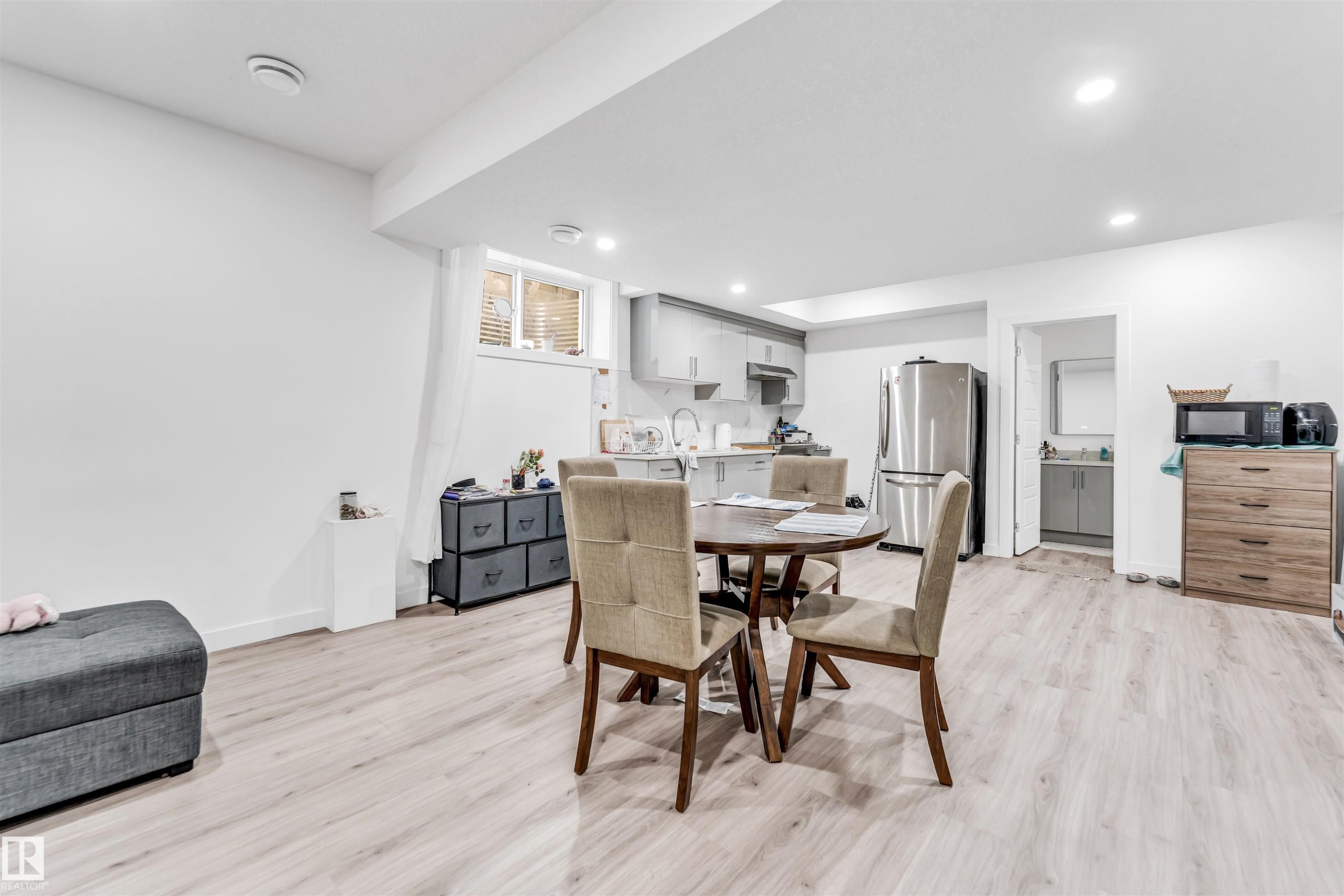 Open-concept living area featuring light-toned flooring, recessed lighting, and a window with blinds - 449 Roberts Crescent, Leduc, AB - Indoor Photo Showing Dining Room