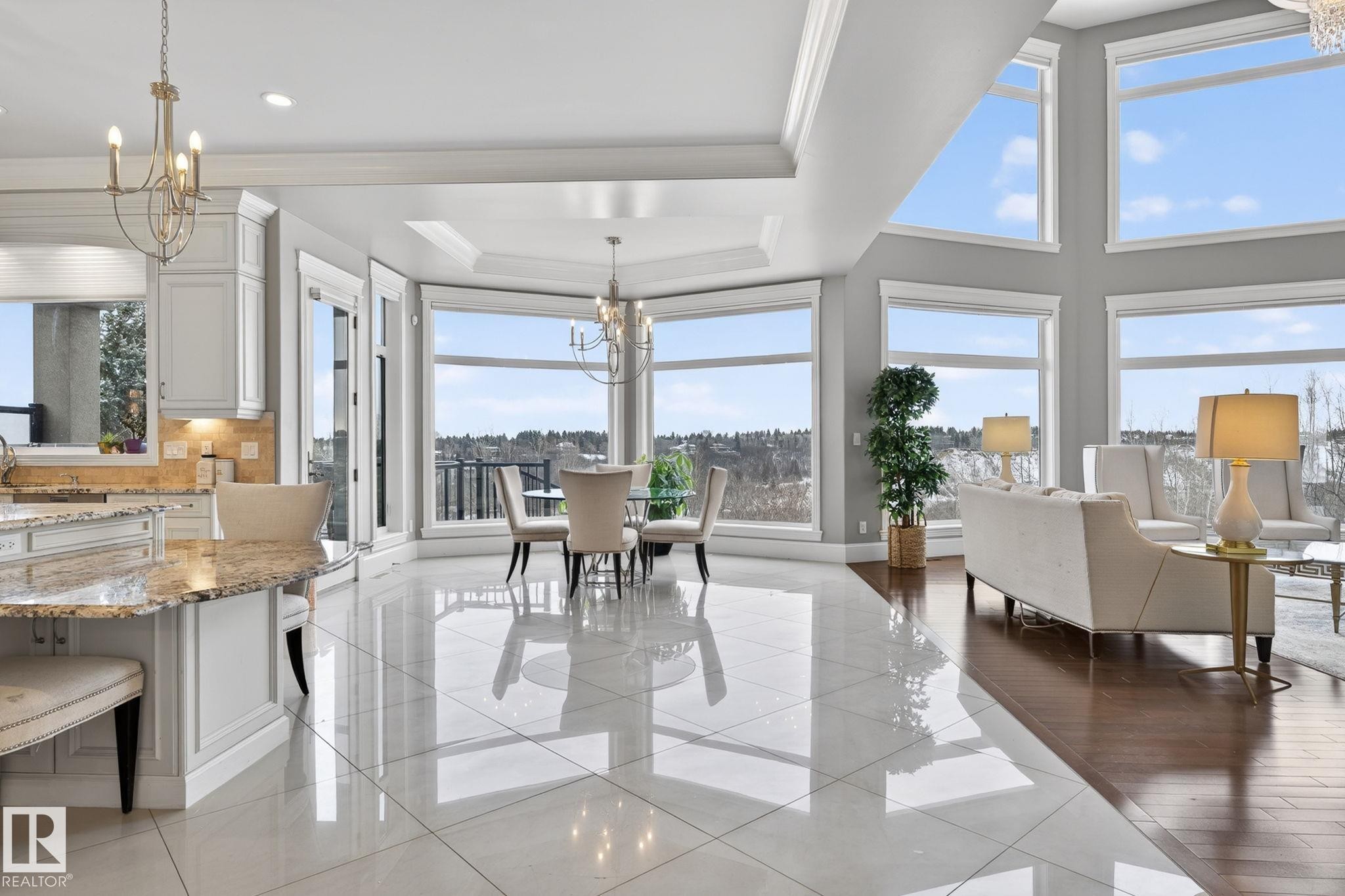 This expansive open-concept living space features large windows that offer scenic views, high ceilings with crown molding, and a combination of gleaming tile and hardwood flooring - 1413 Woodward Crescent, Edmonton, AB - Indoor