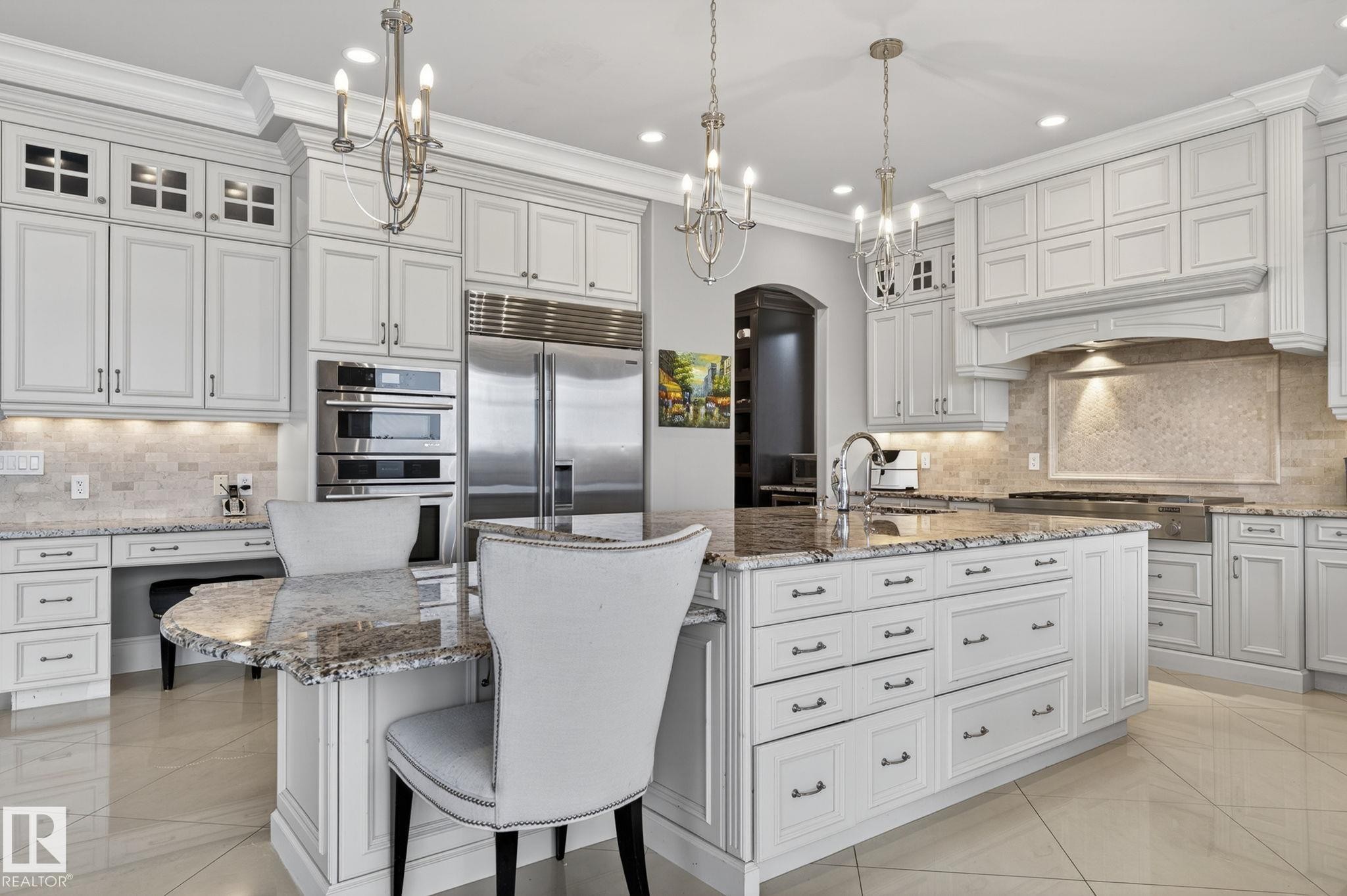 This kitchen features extensive white cabinetry, stainless steel appliances, and granite countertops - 1413 Woodward Crescent, Edmonton, AB - Indoor Photo Showing Kitchen With Upgraded Kitchen