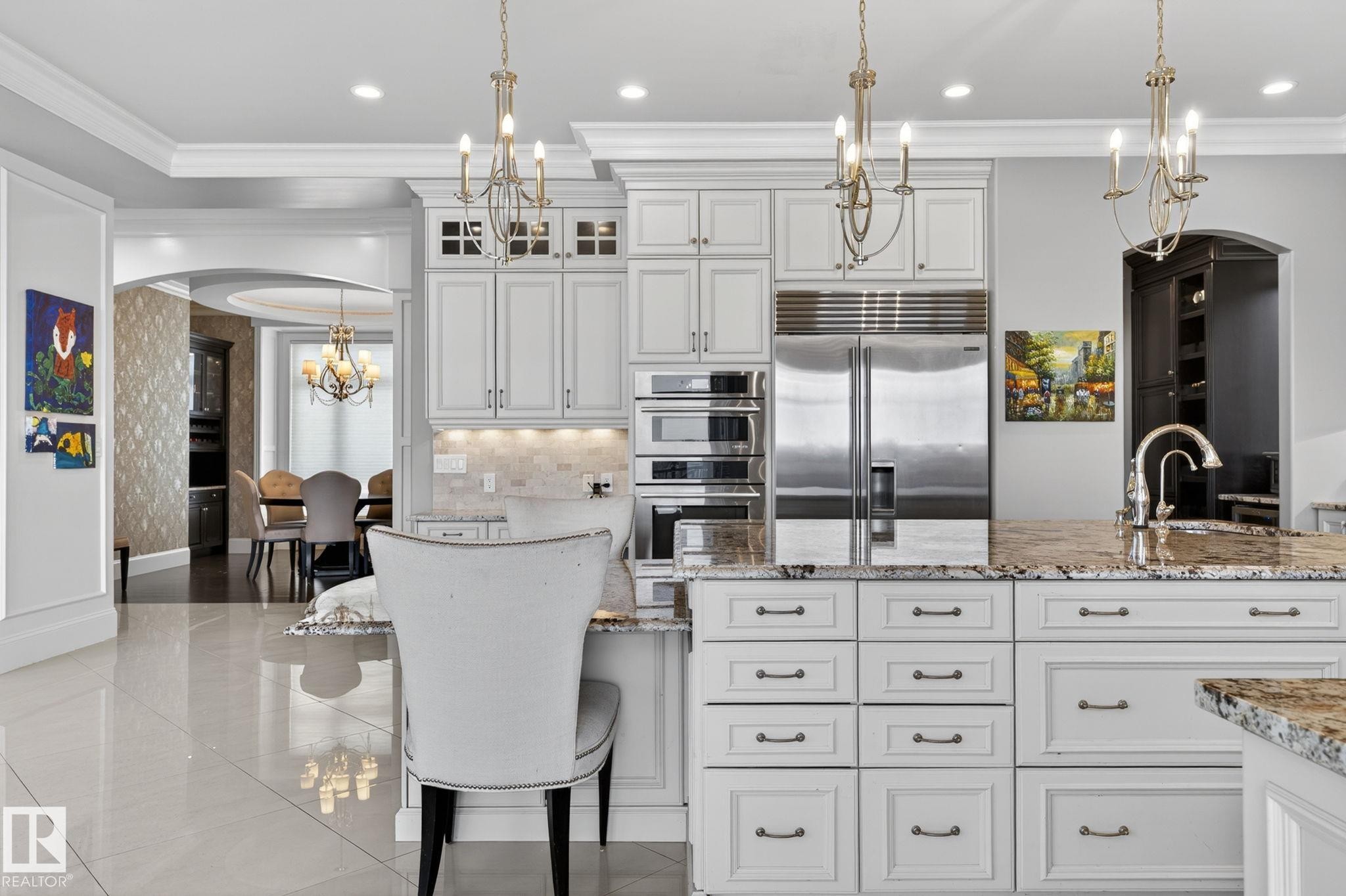 The kitchen features white cabinetry with dark hardware, granite countertops, and stainless steel appliances - 1413 Woodward Crescent, Edmonton, AB - Indoor Photo Showing Kitchen With Upgraded Kitchen
