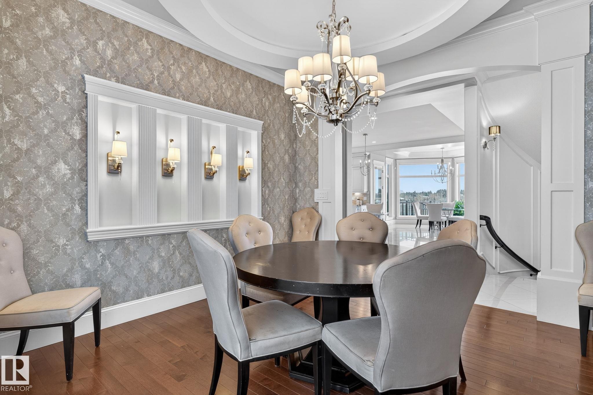 Formal dining area featuring hardwood floors and an ornate chandelier - 1413 Woodward Crescent, Edmonton, AB - Indoor Photo Showing Dining Room