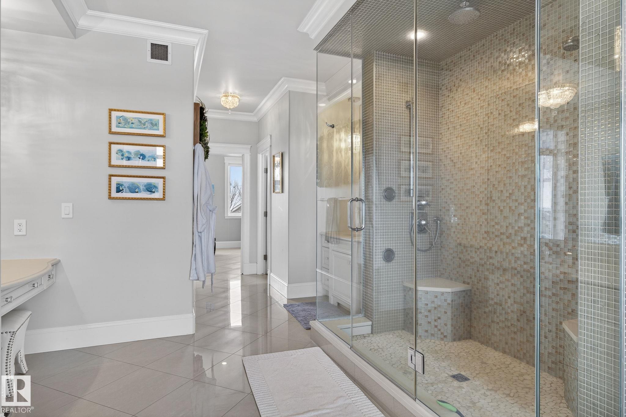 This bathroom features a spacious glass-enclosed shower with mosaic tile walls and a pebble floor, complete with a built-in bench and modern shower fixtures - 1413 Woodward Crescent, Edmonton, AB - Indoor Photo Showing Bathroom