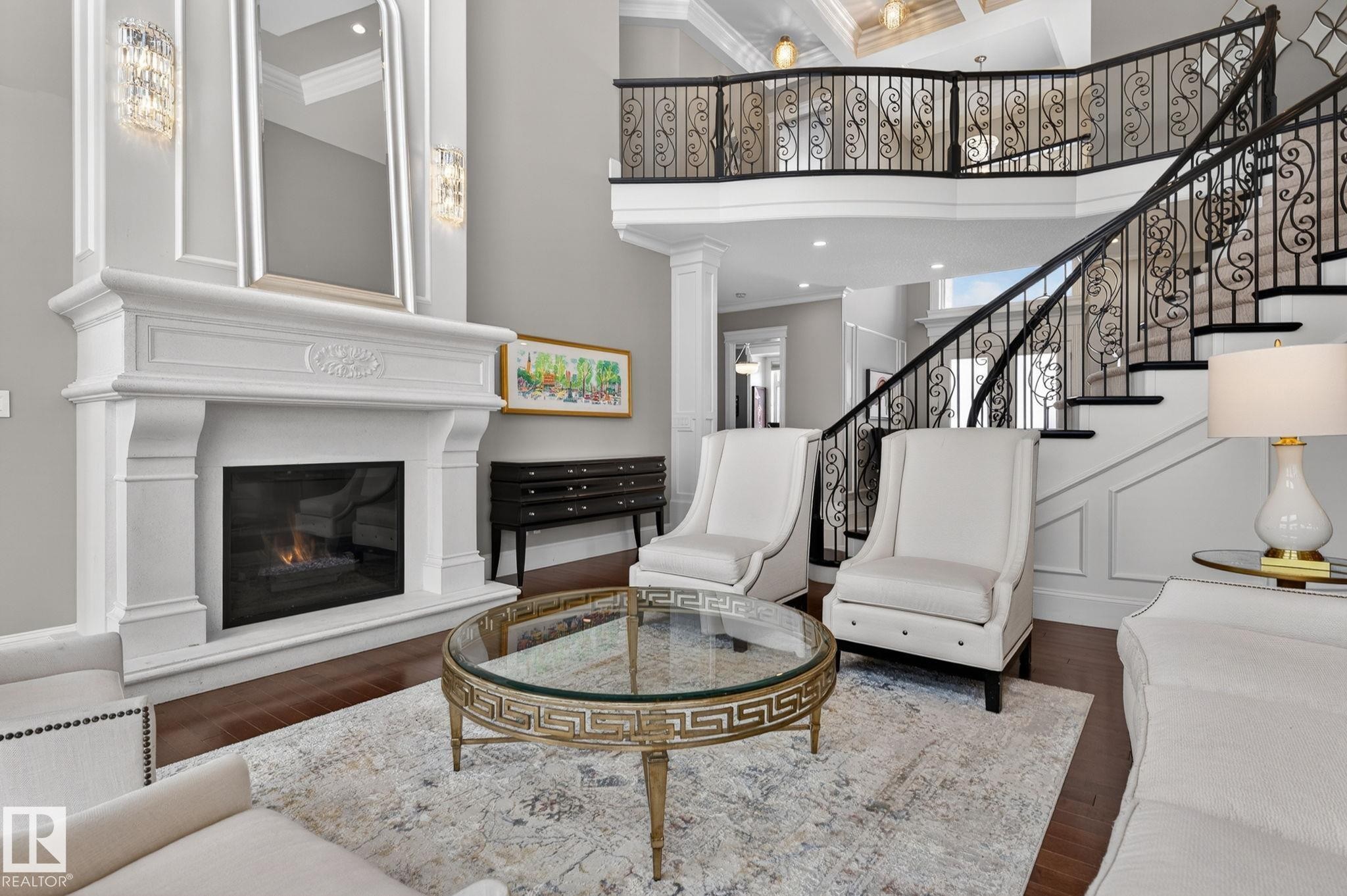 This elegant living space features a grand fireplace with a decorative mantel and a large mirror above - 1413 Woodward Crescent, Edmonton, AB - Indoor Photo Showing Living Room With Fireplace