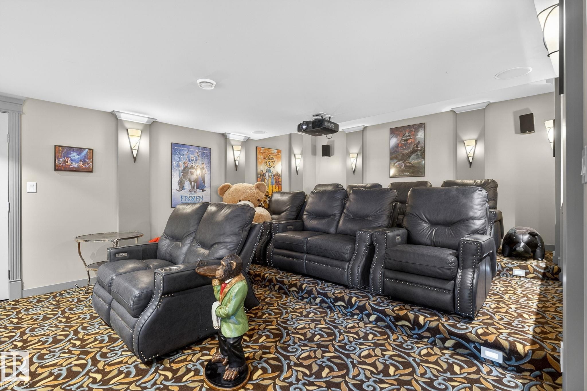 This entertainment space features a projector, built-in speakers, and wall sconces - 1413 Woodward Crescent, Edmonton, AB - Indoor Photo Showing Living Room