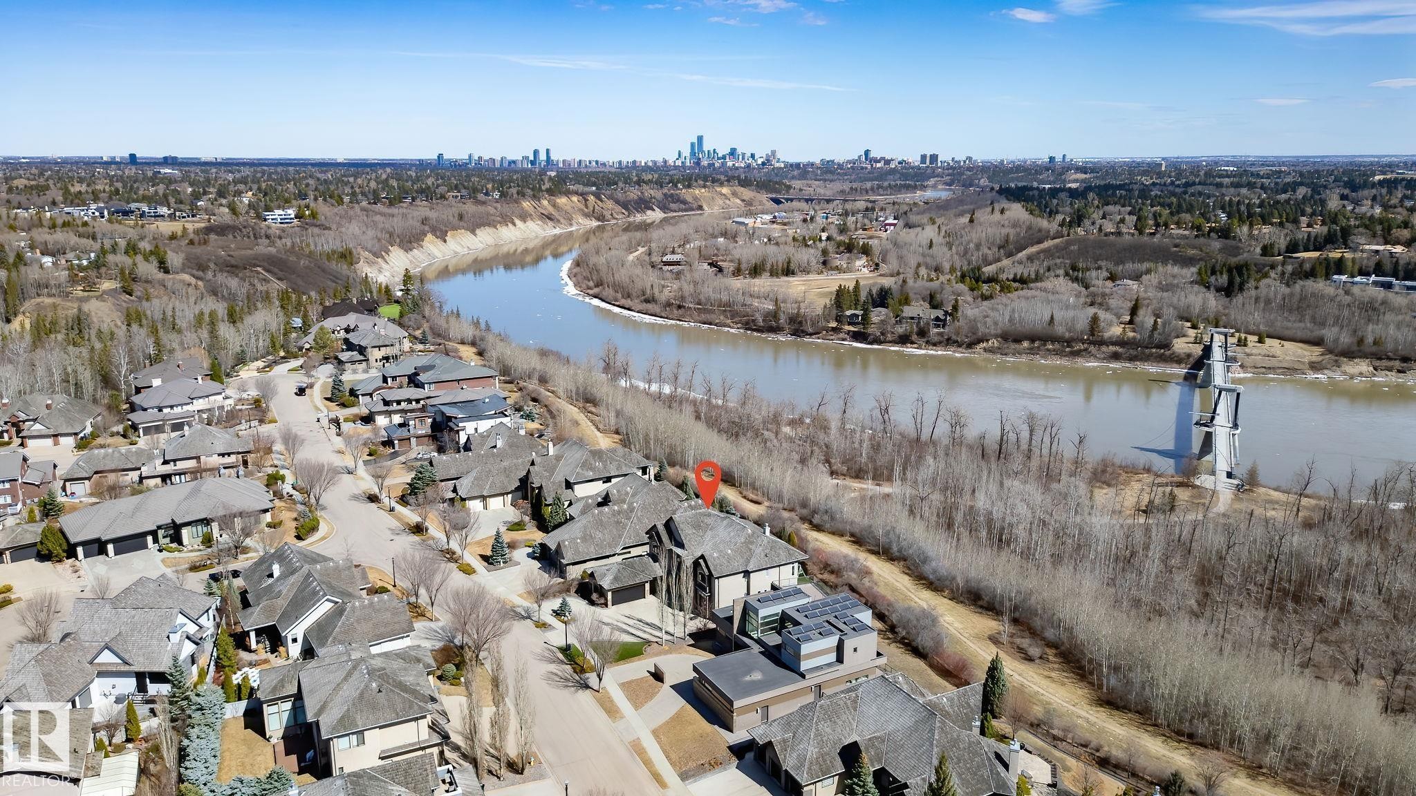 Aerial perspective of a property within a residential development, bordered by a river and natural landscape - 1413 Woodward Crescent, Edmonton, AB - Outdoor