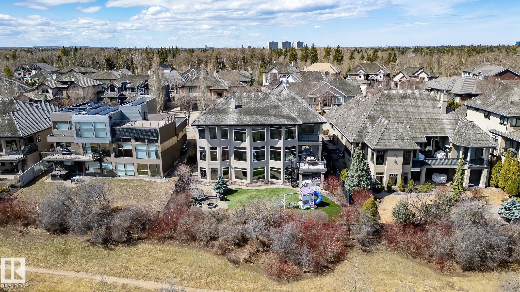 Multi-level residence featuring a terraced backyard with mature landscaping and a fire pit area - 1413 Woodward Crescent, Edmonton, AB - Outdoor With Facade