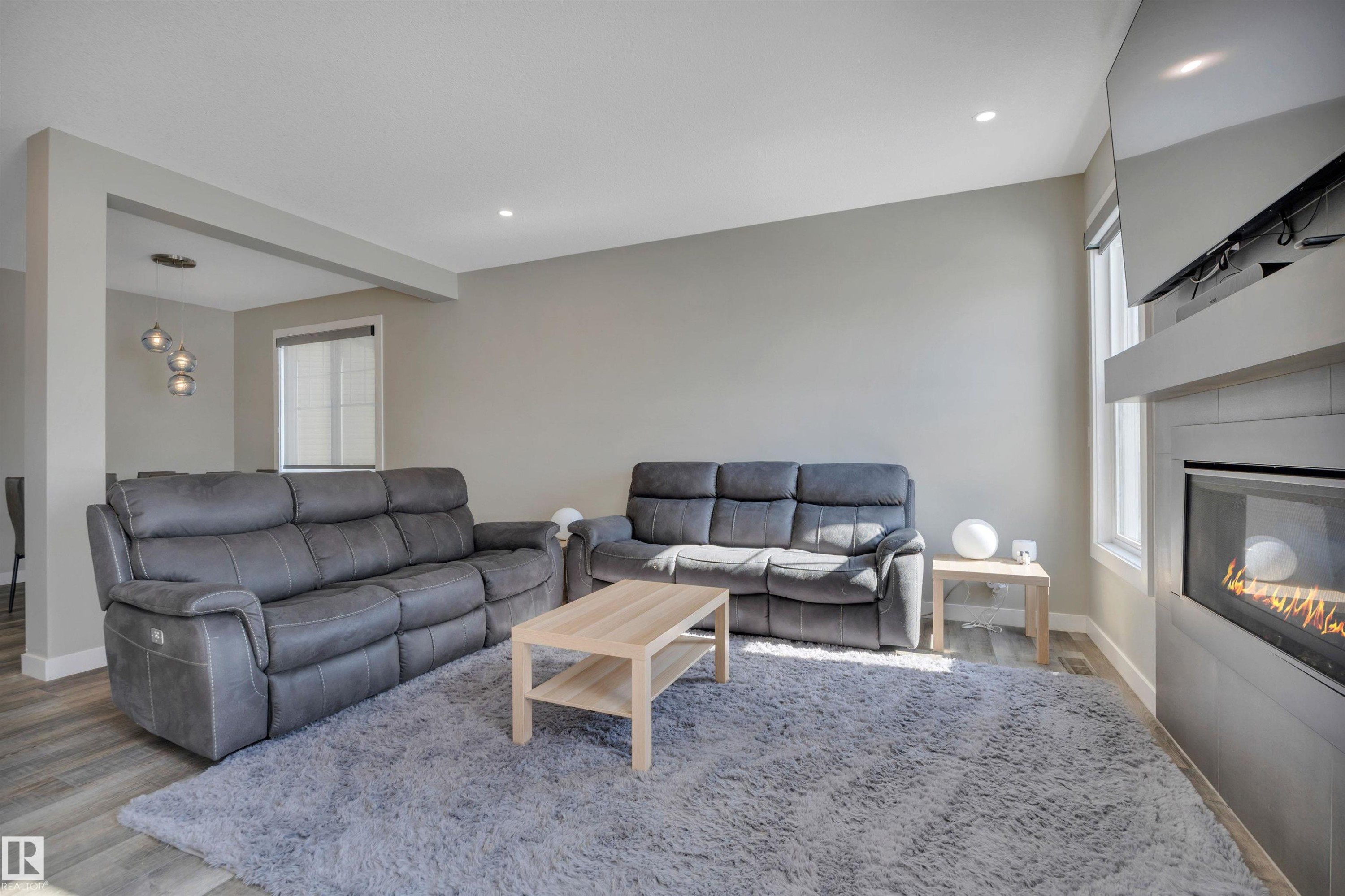 15 Promenade Point(E), Beaumont, AB - Indoor Photo Showing Living Room With Fireplace