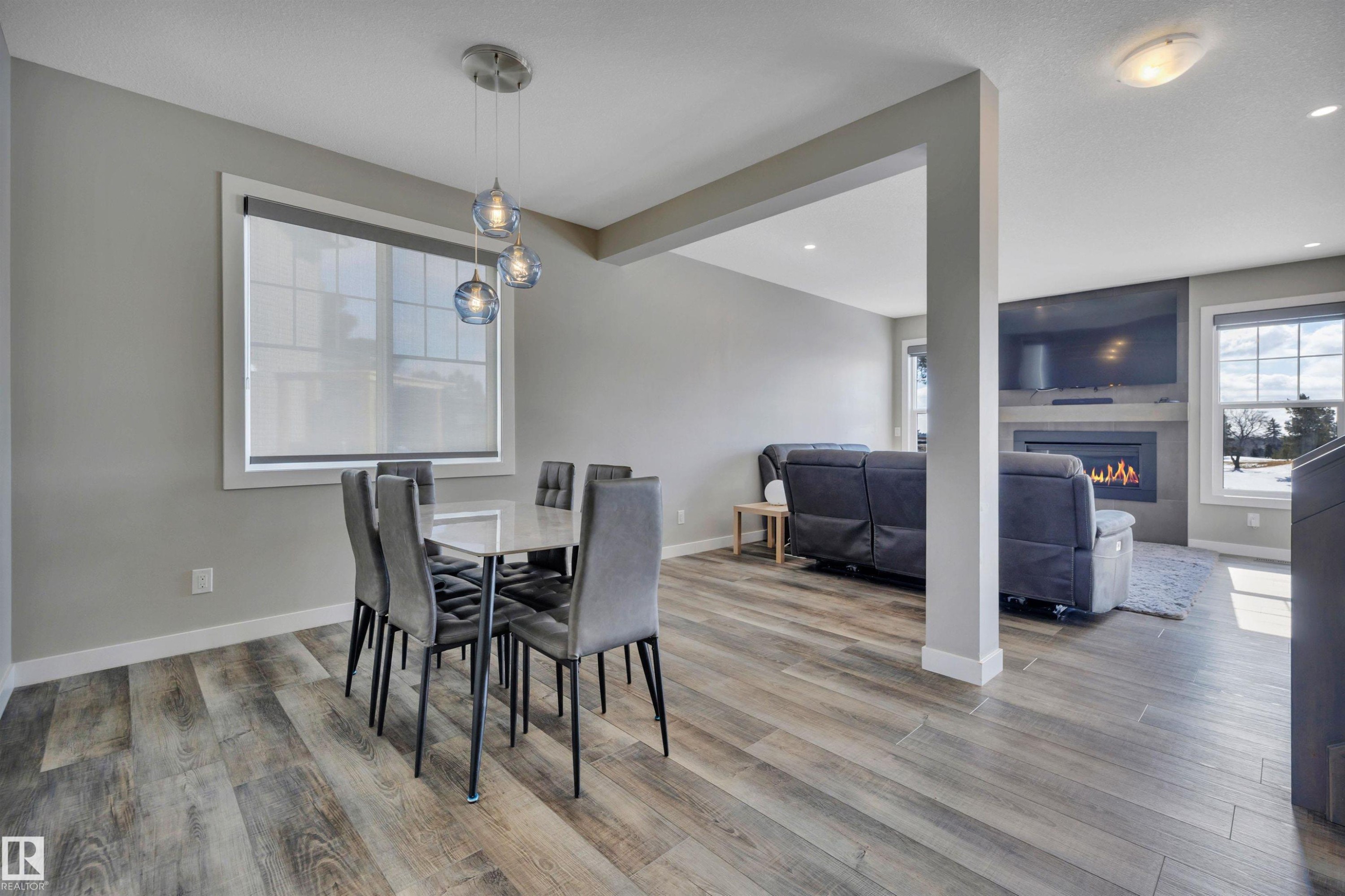 15 Promenade Point(E), Beaumont, AB - Indoor Photo Showing Dining Room With Fireplace