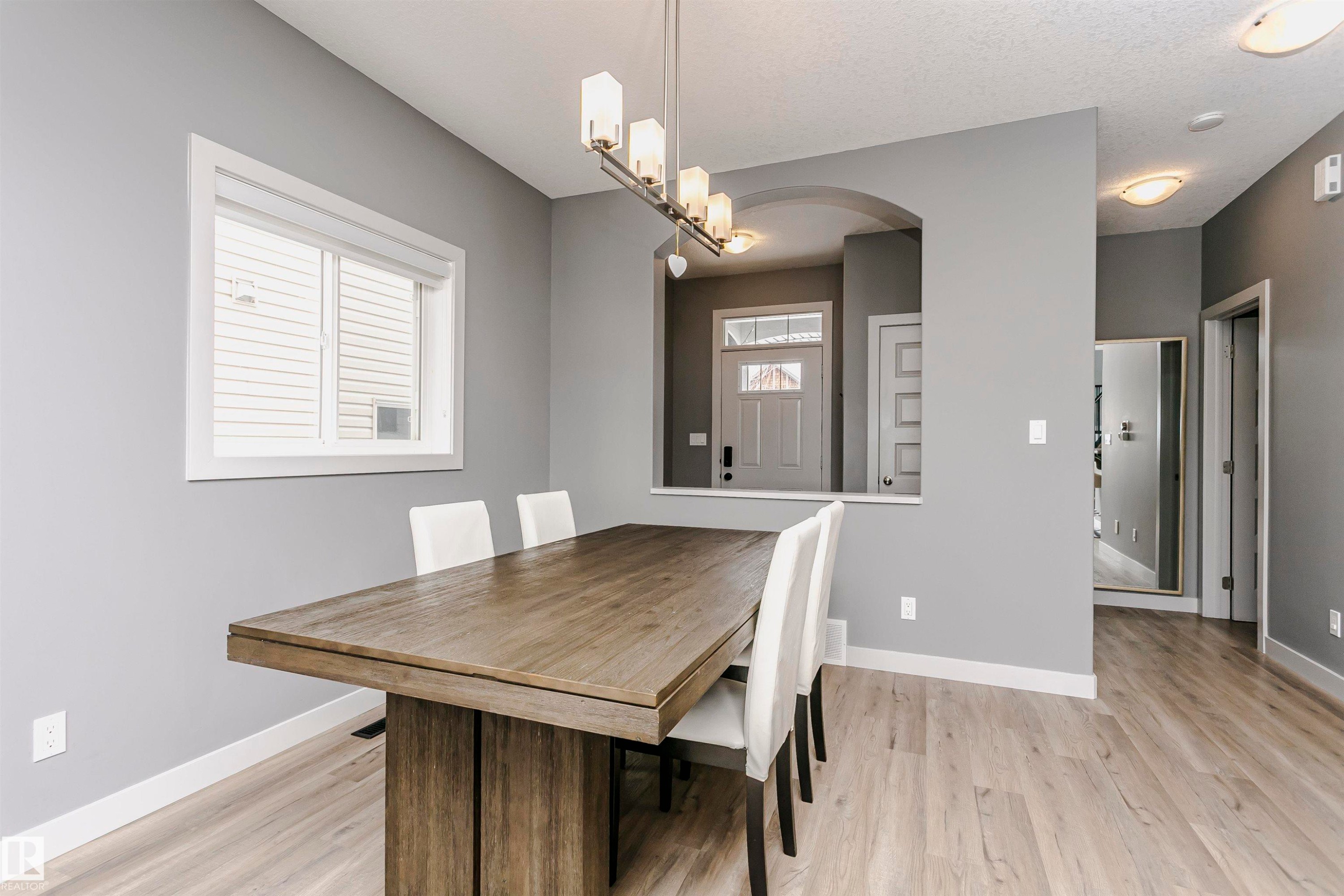 The property features light-toned flooring and a spacious window with white trim - 21807 97 Avenue, Edmonton, AB - Indoor Photo Showing Dining Room