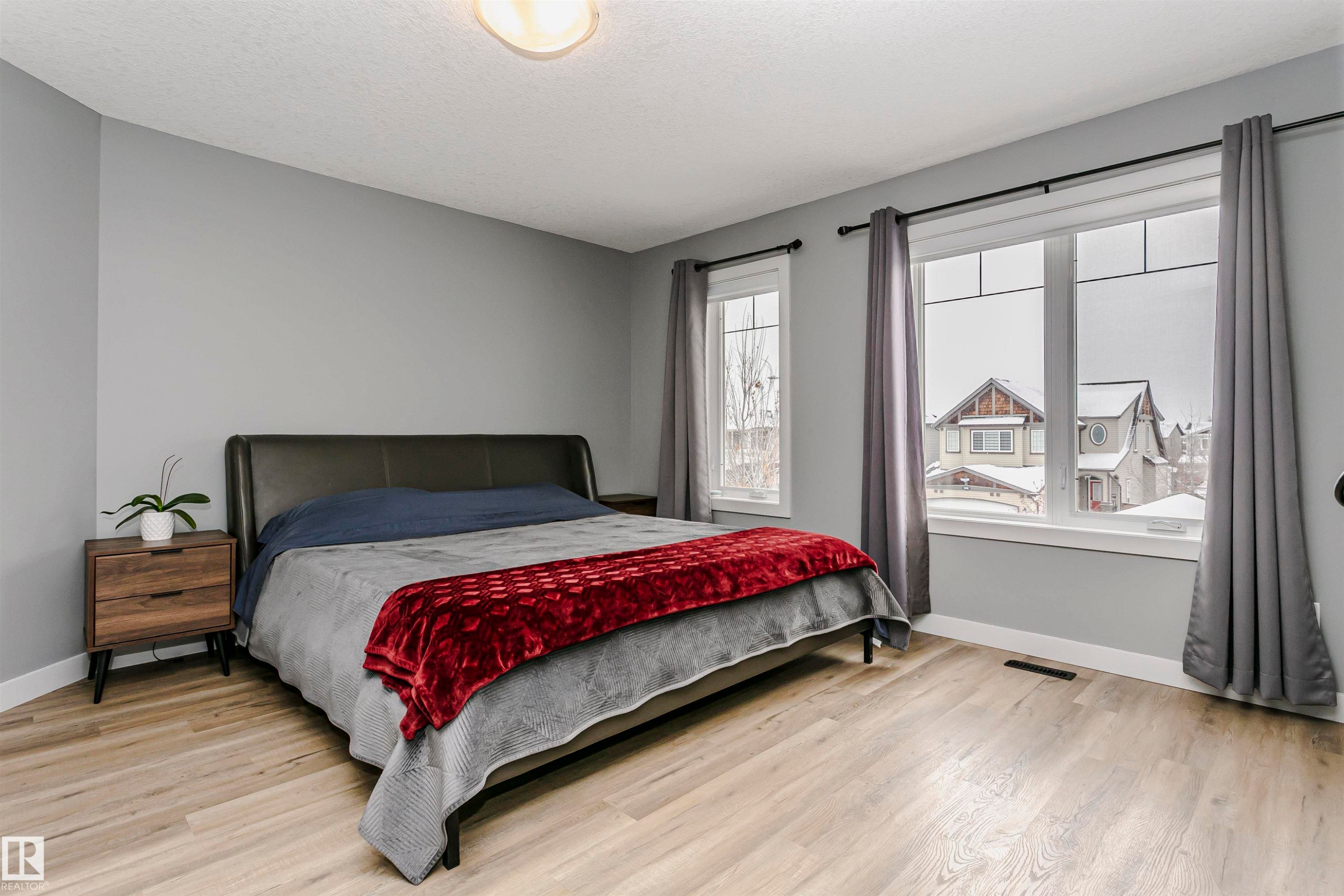 This inviting bedroom features light-colored flooring and neutral gray walls - 21807 97 Avenue, Edmonton, AB - Indoor Photo Showing Bedroom