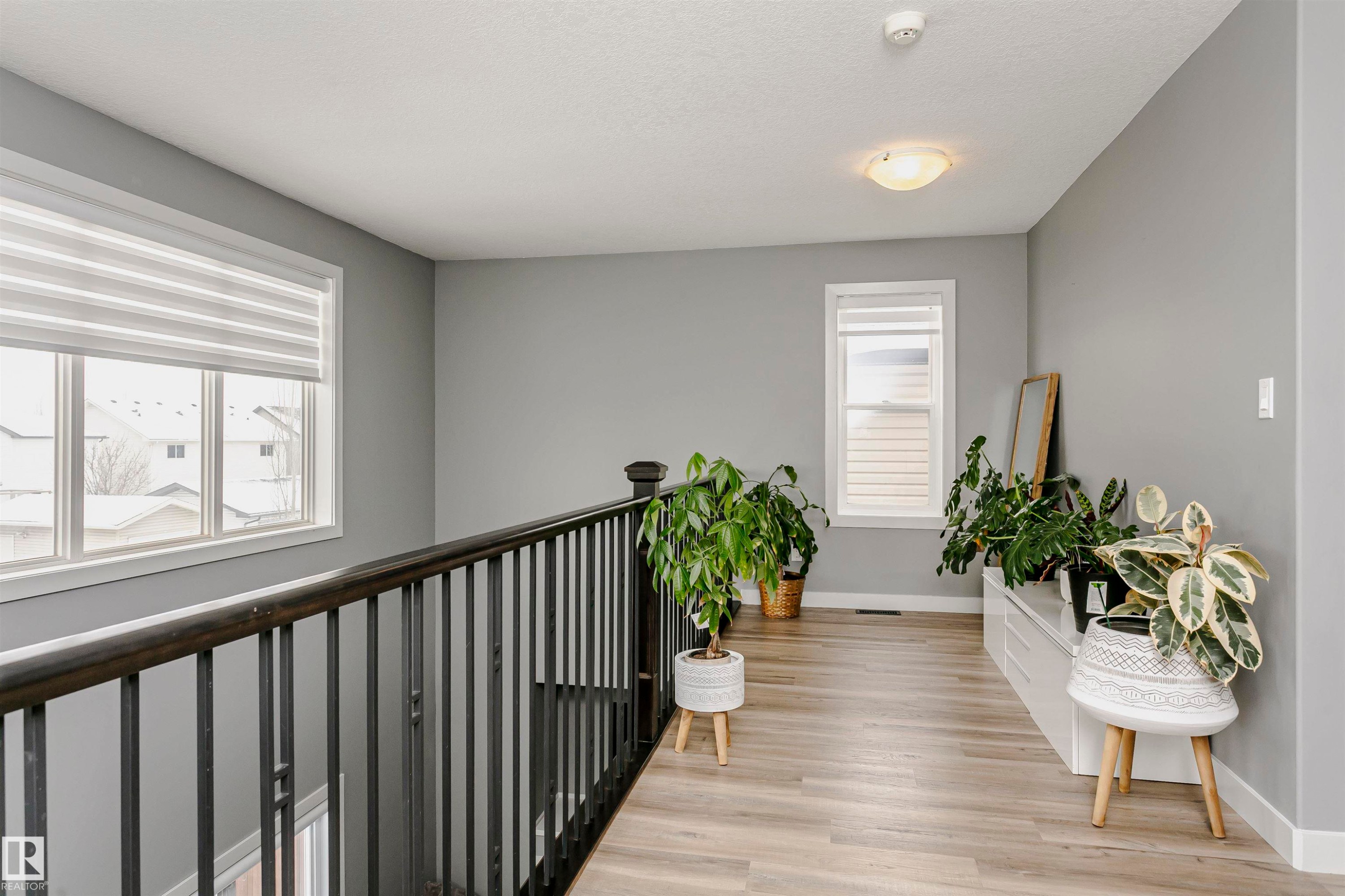 This property features a landing with light wood-style flooring and light grey walls - 21807 97 Avenue, Edmonton, AB - Indoor Photo Showing Other Room