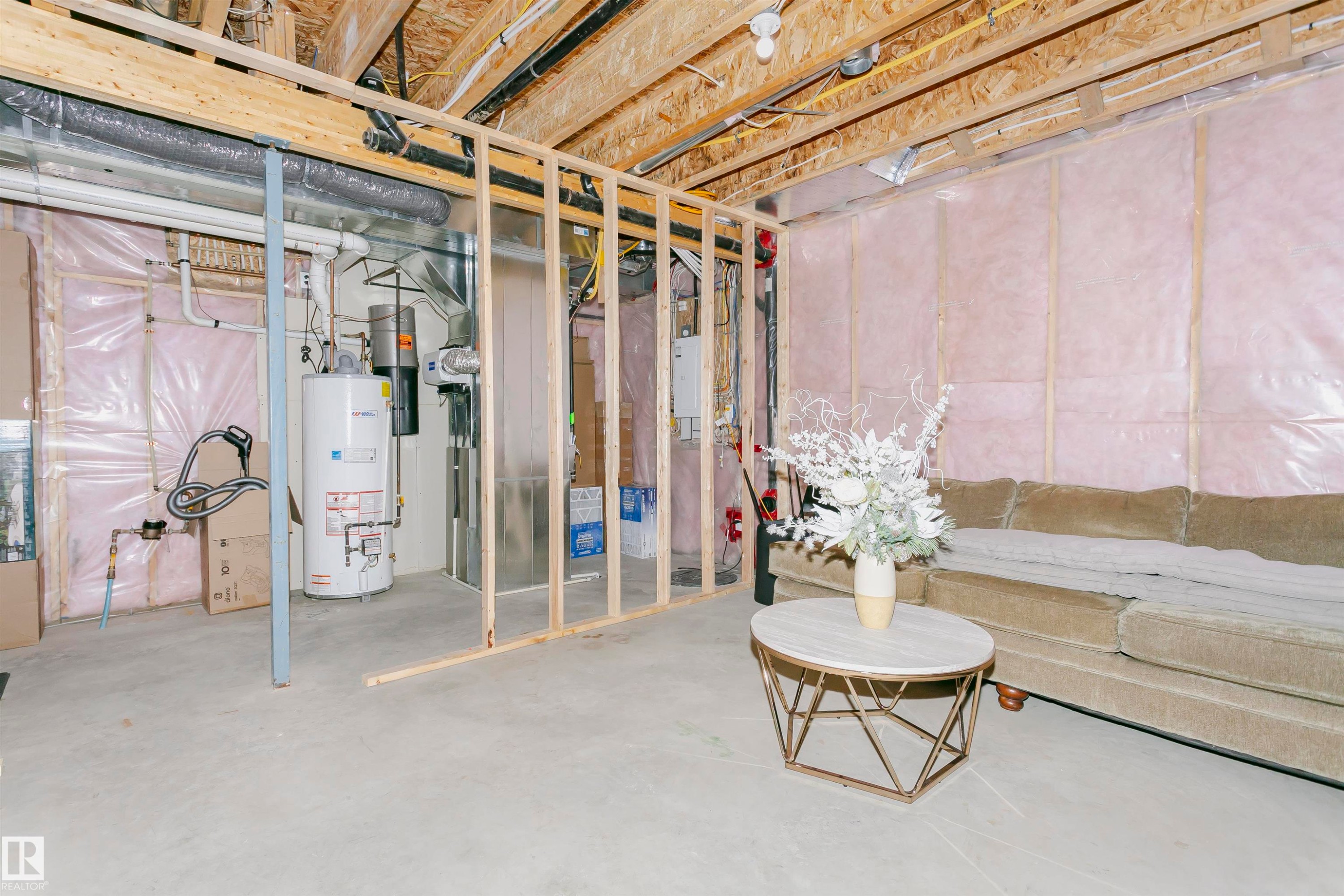 The property includes an unfinished basement with exposed wooden joists and framing, a concrete floor, and insulation visible on the walls - 21807 97 Avenue, Edmonton, AB - Indoor Photo Showing Basement