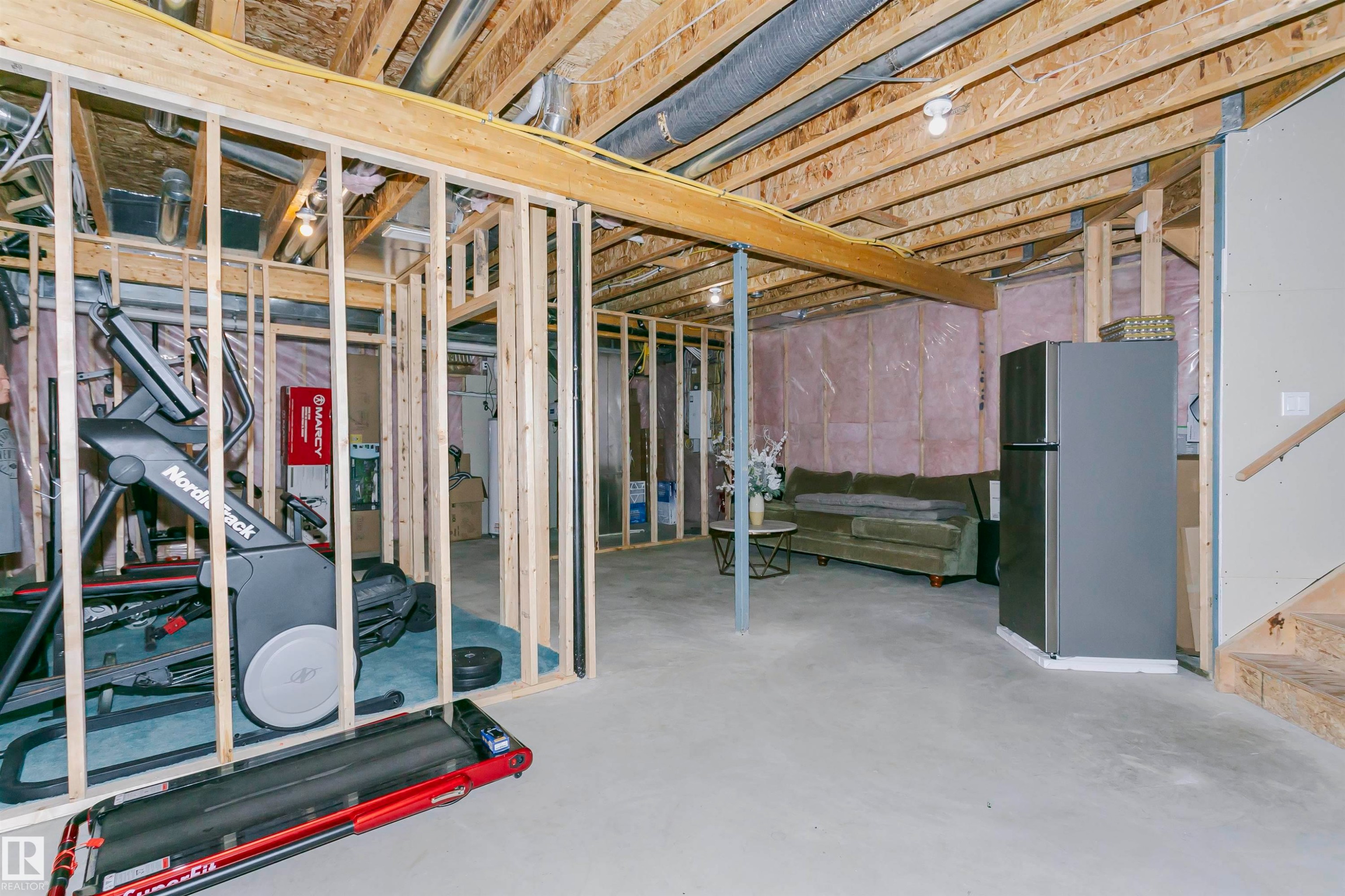 The property features a partially finished basement with exposed wooden beams and framing - 21807 97 Avenue, Edmonton, AB - Indoor Photo Showing Basement