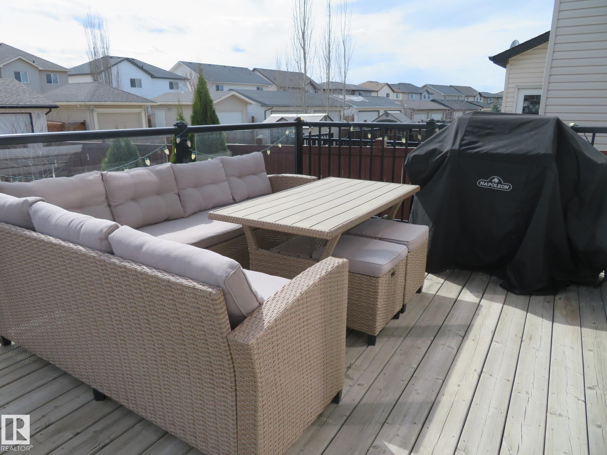 Spacious wood-planked deck featuring a glass and metal railing - 21807 97 Avenue, Edmonton, AB - Outdoor With Deck Patio Veranda