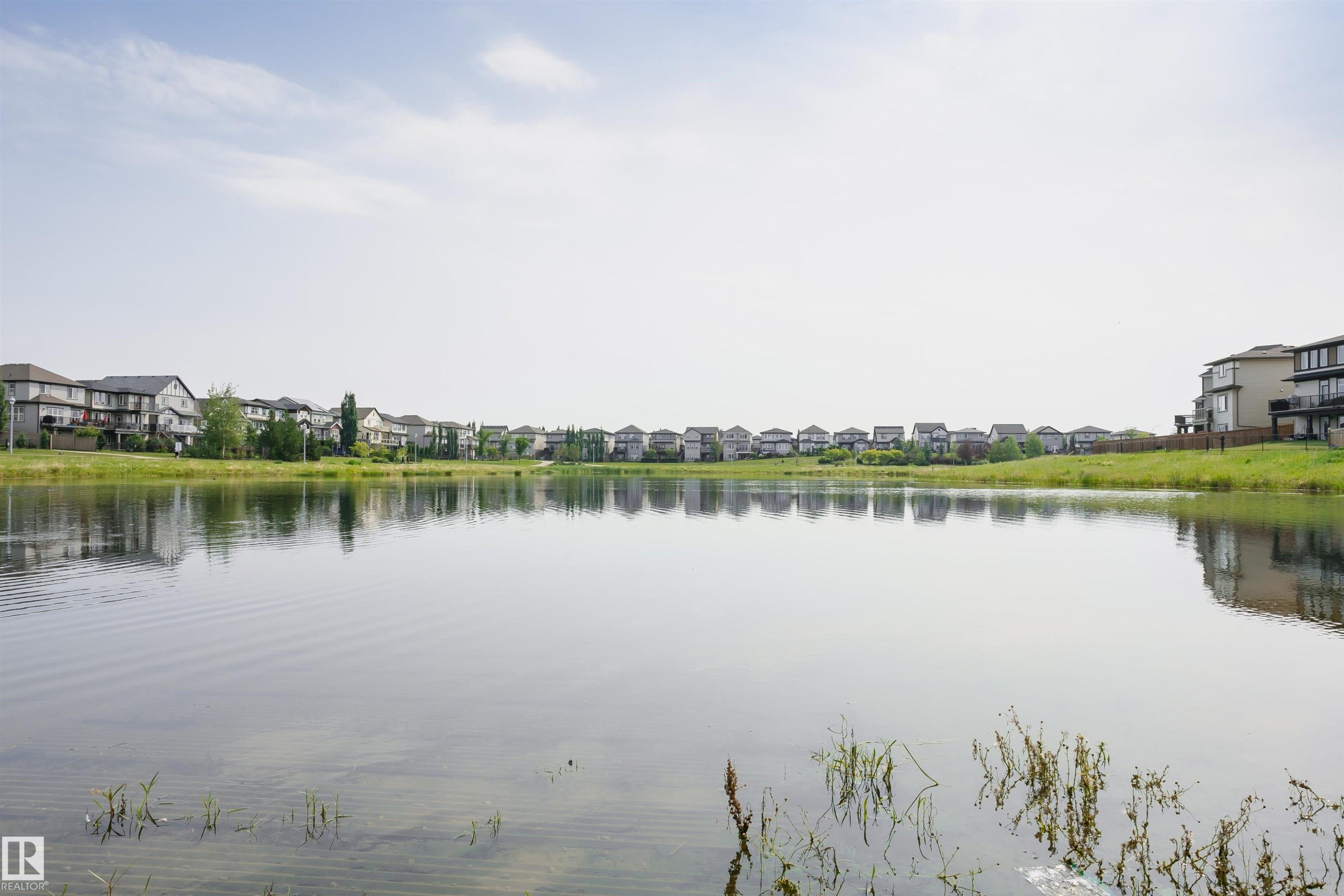 The property is located in a community with a large body of water, offering scenic views and a tranquil environment - 21807 97 Avenue, Edmonton, AB - Outdoor With Body Of Water With View
