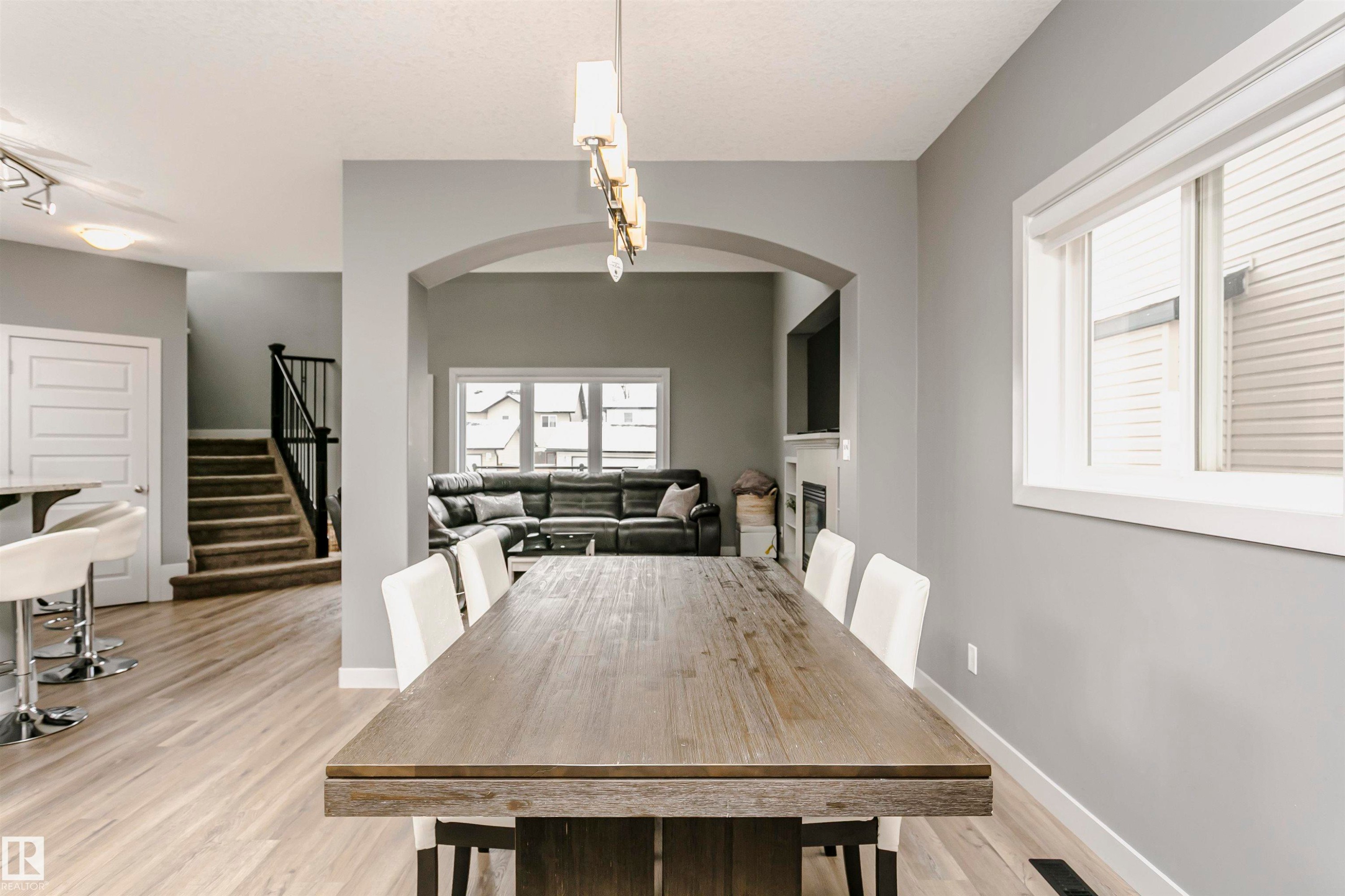 The property features an open-concept layout with light-colored flooring throughout - 21807 97 Avenue, Edmonton, AB - Indoor Photo Showing Dining Room