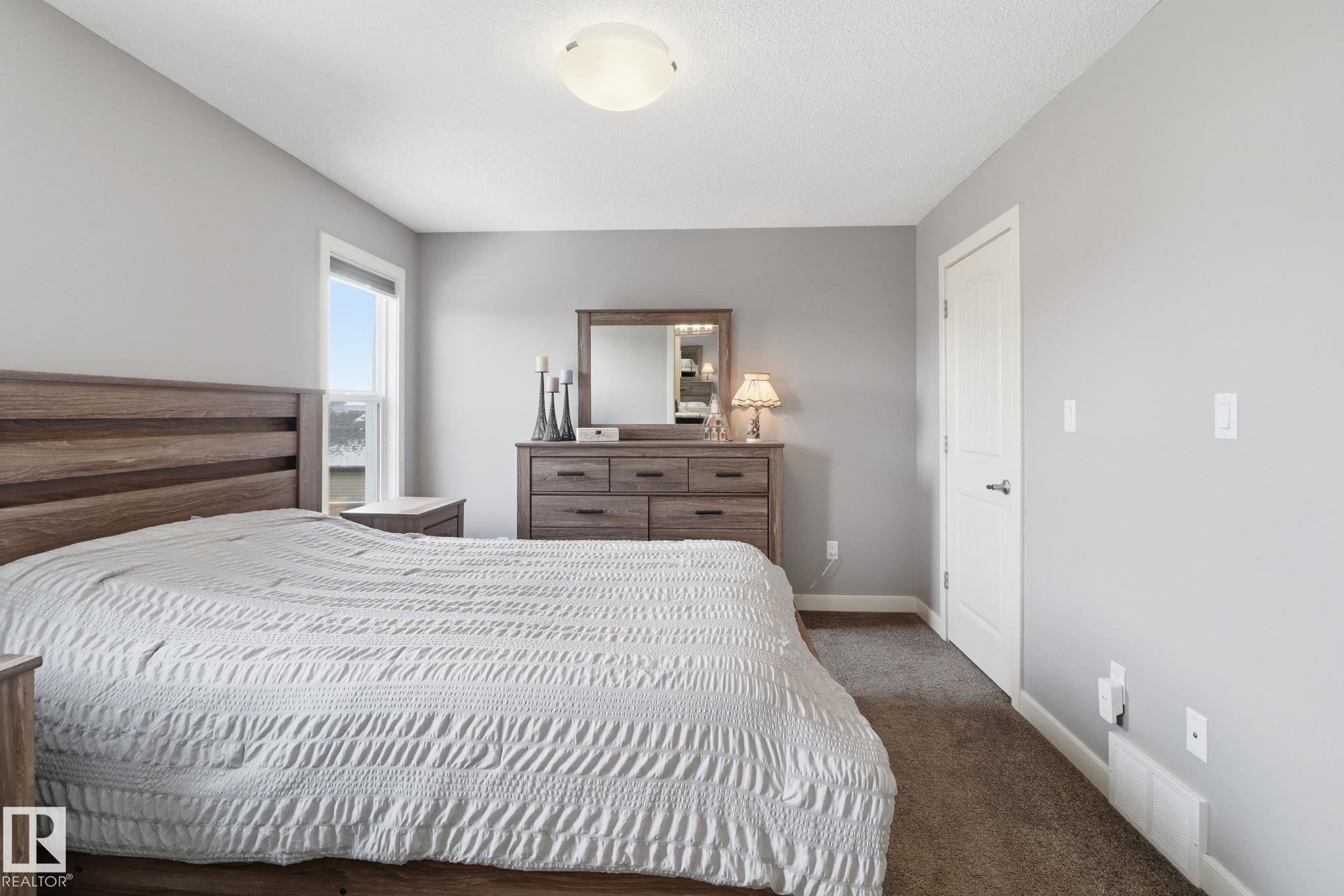 This room features light grey walls and brown carpet, with a window providing natural light - 430 Watt Boulevard, Edmonton, AB - Indoor Photo Showing Bedroom