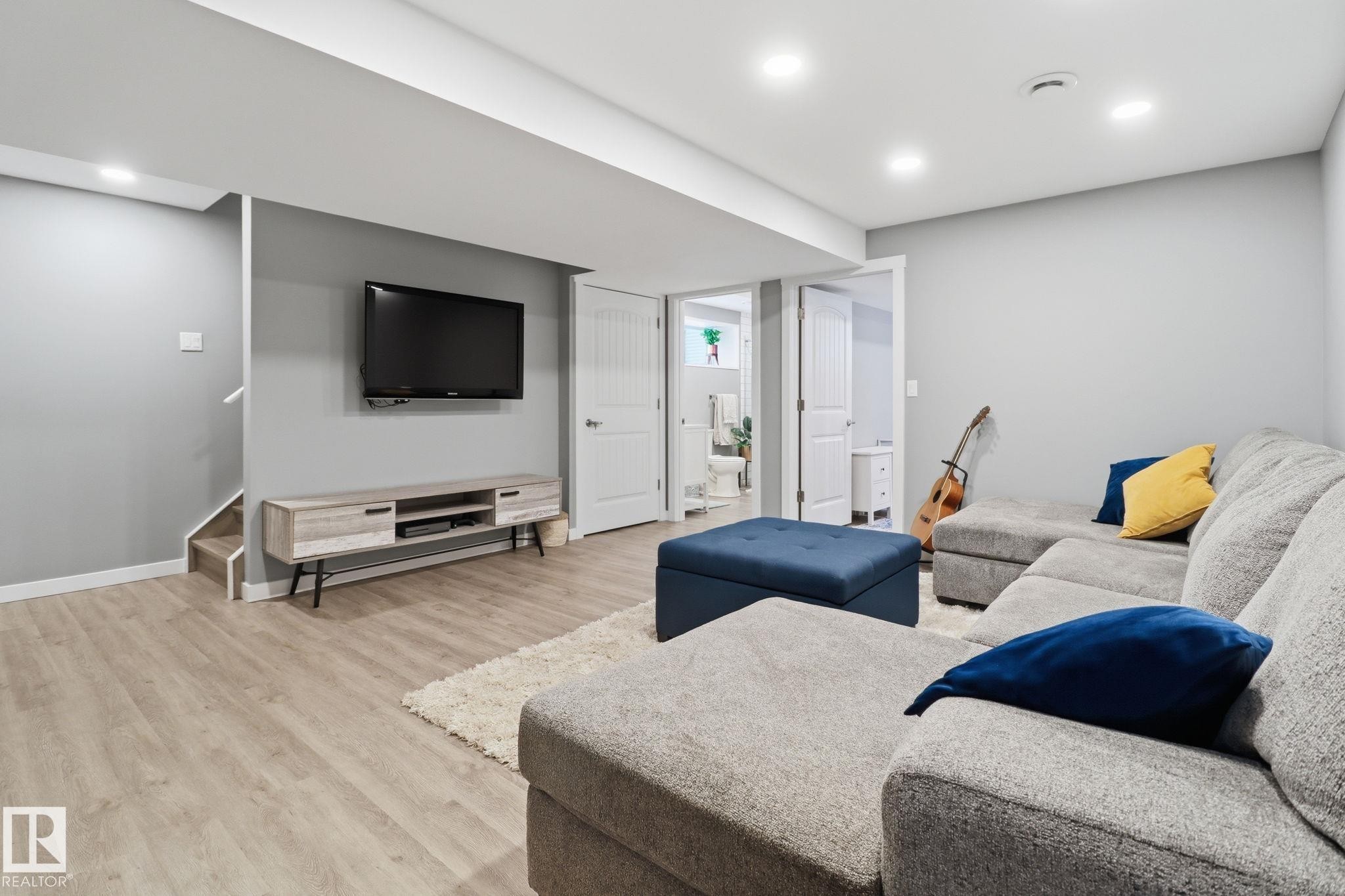 Spacious living area featuring light-toned flooring, recessed lighting, and a white interior door - 430 Watt Boulevard, Edmonton, AB - Indoor