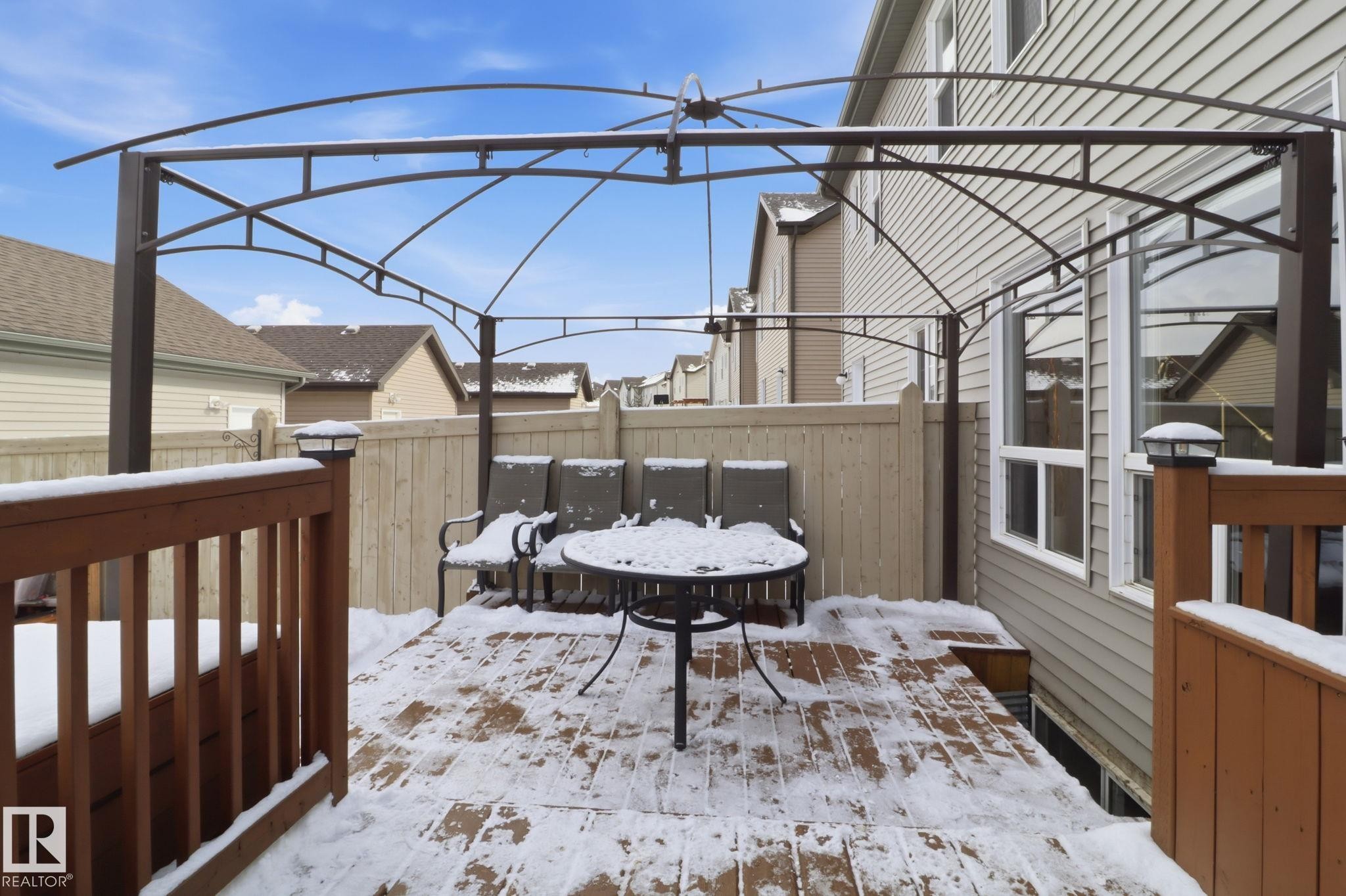 The property includes a spacious wooden deck featuring a metal pergola structure - 430 Watt Boulevard, Edmonton, AB - Outdoor With Deck Patio Veranda