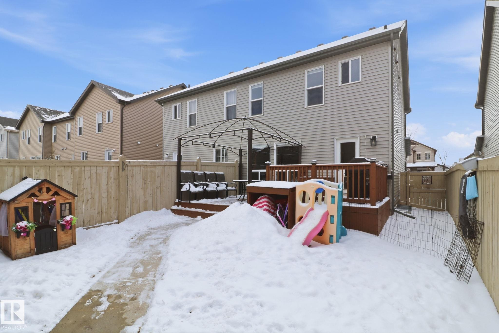 The property features a fenced yard with a deck, providing an outdoor entertaining space - 430 Watt Boulevard, Edmonton, AB - Outdoor With Deck Patio Veranda